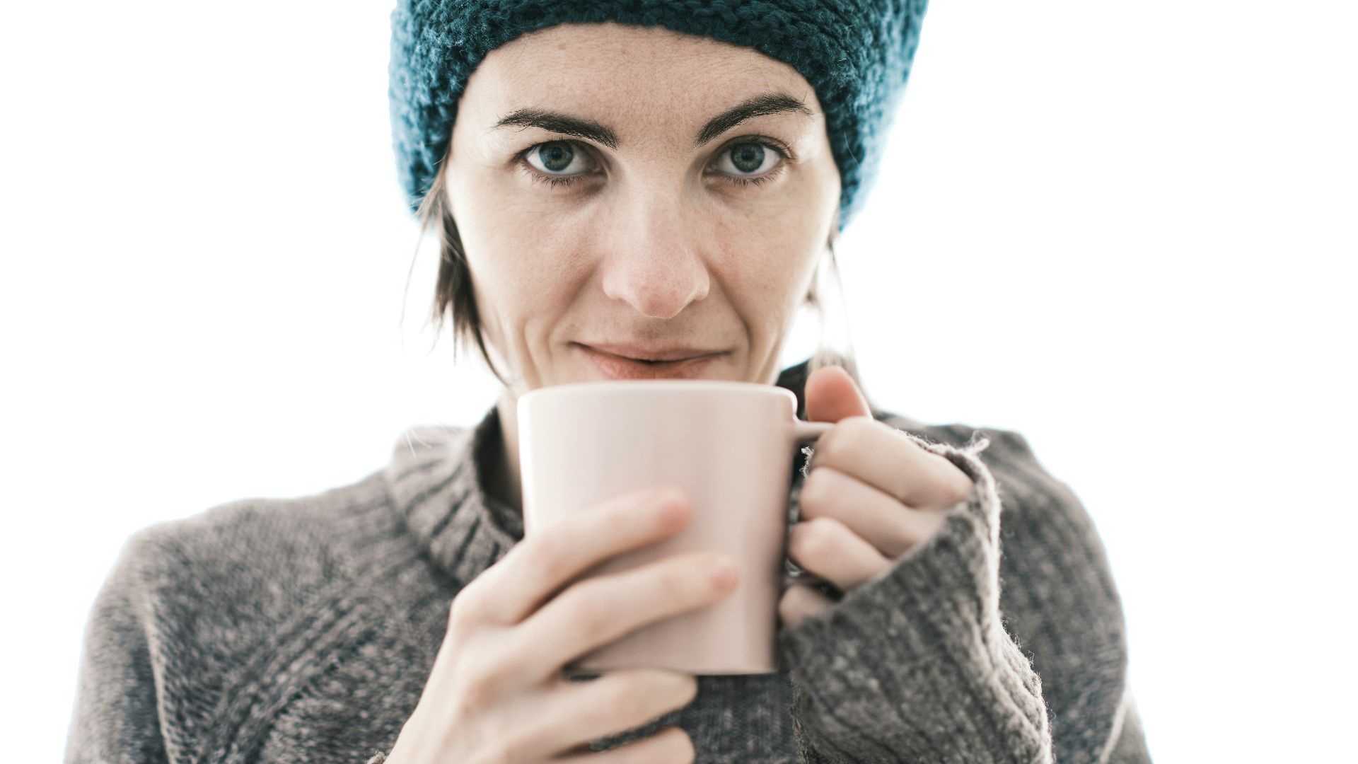 a woman is holding a cup of coffee