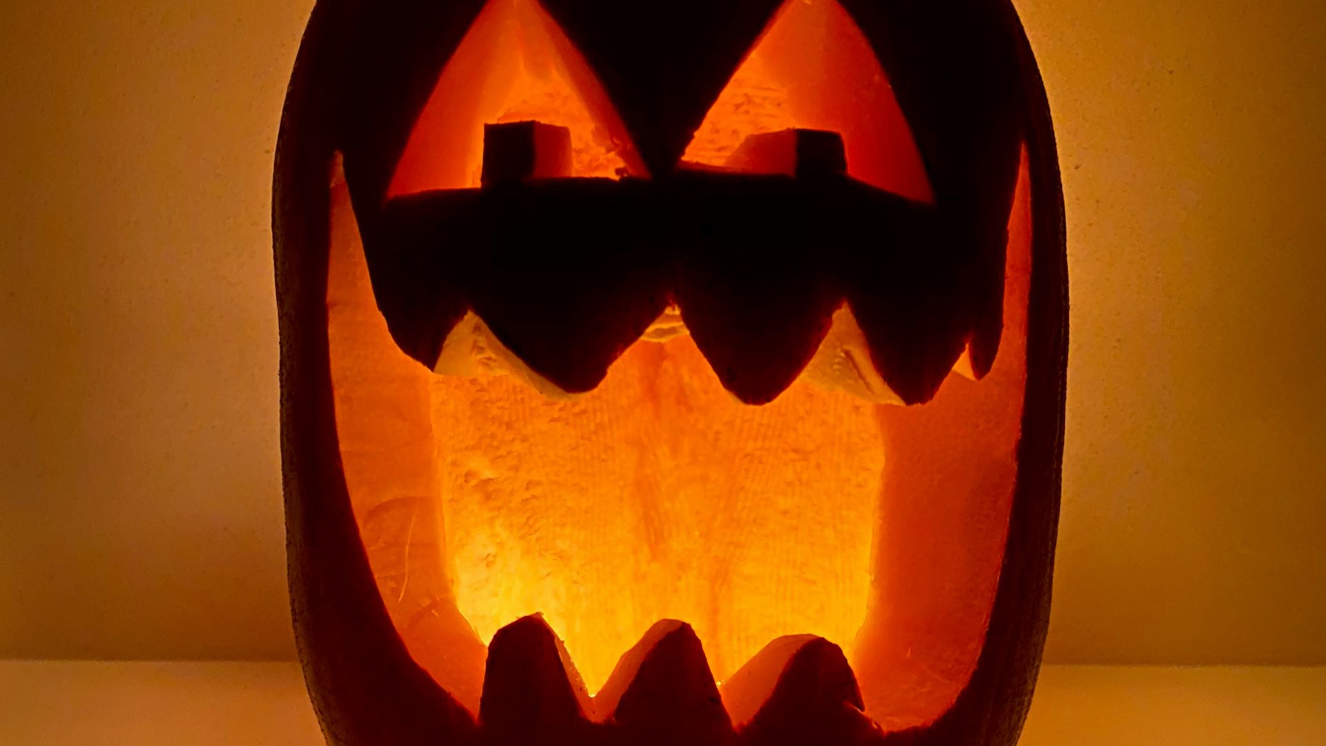 jack o lantern lamp turned on on white table