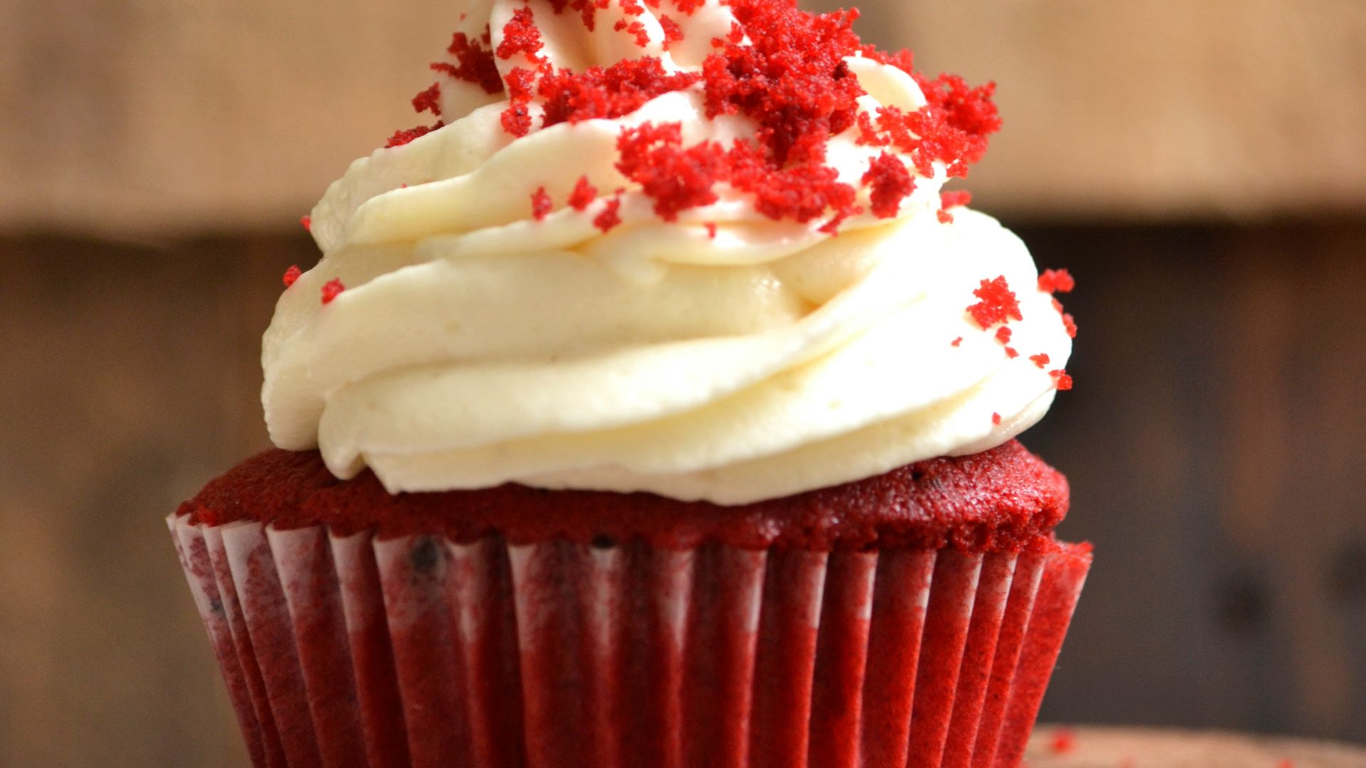 white and red cupcake with white icing on top
