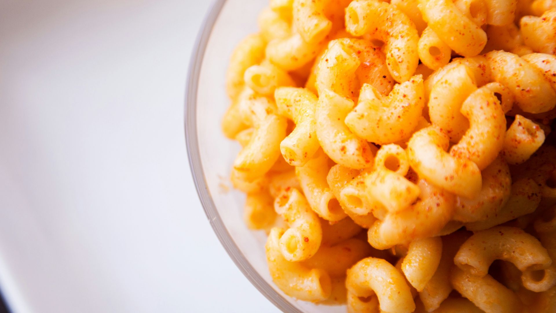 yellow pasta on clear glass bowl