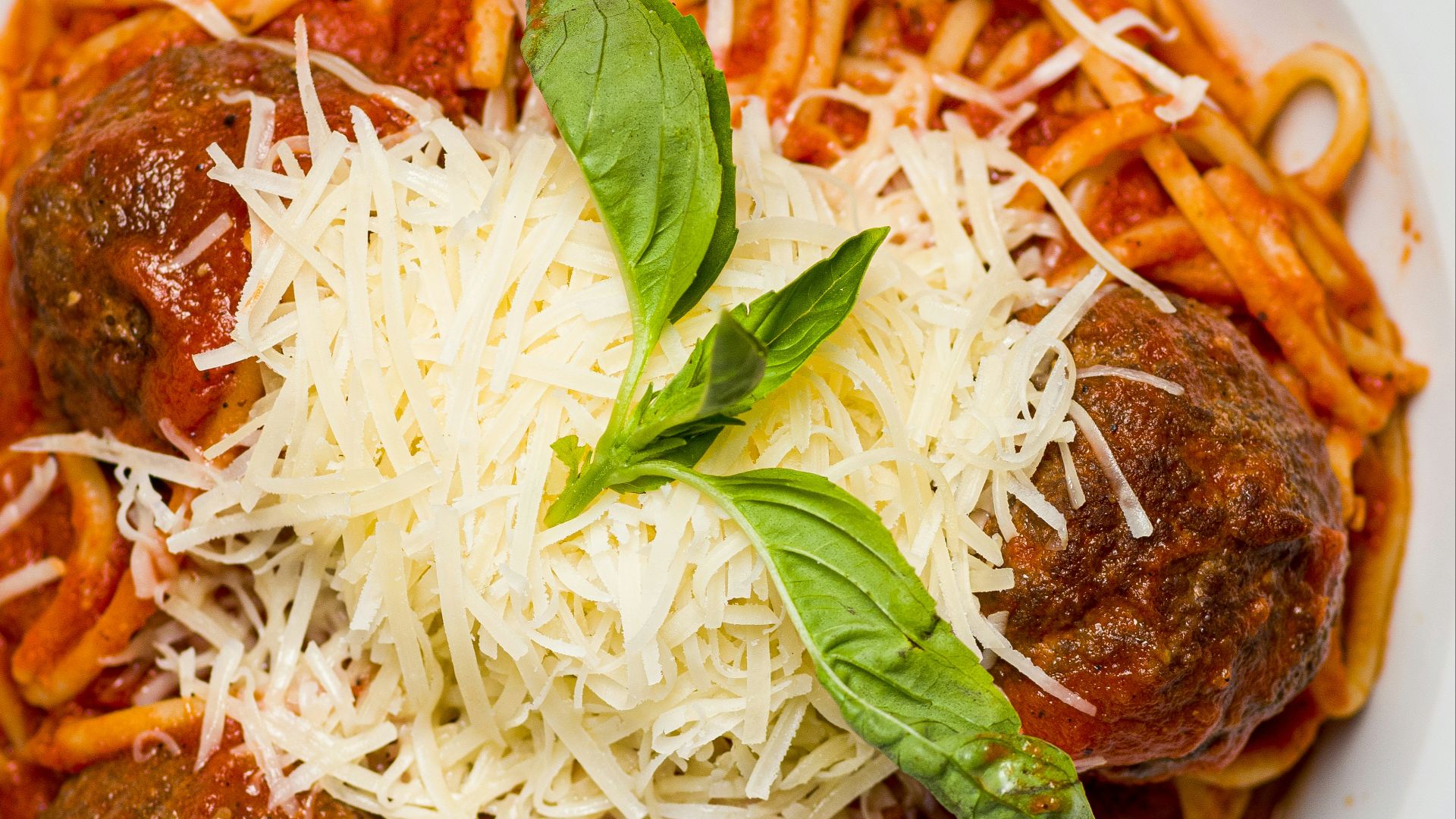 a white plate topped with spaghetti and meatballs