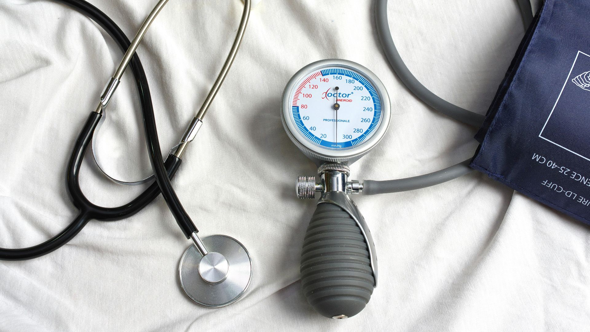 a stethoscope laying on top of a bed next to a medical bag