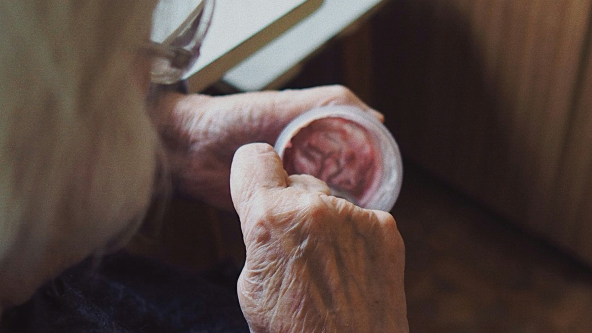 woman in black sweater holding white paper