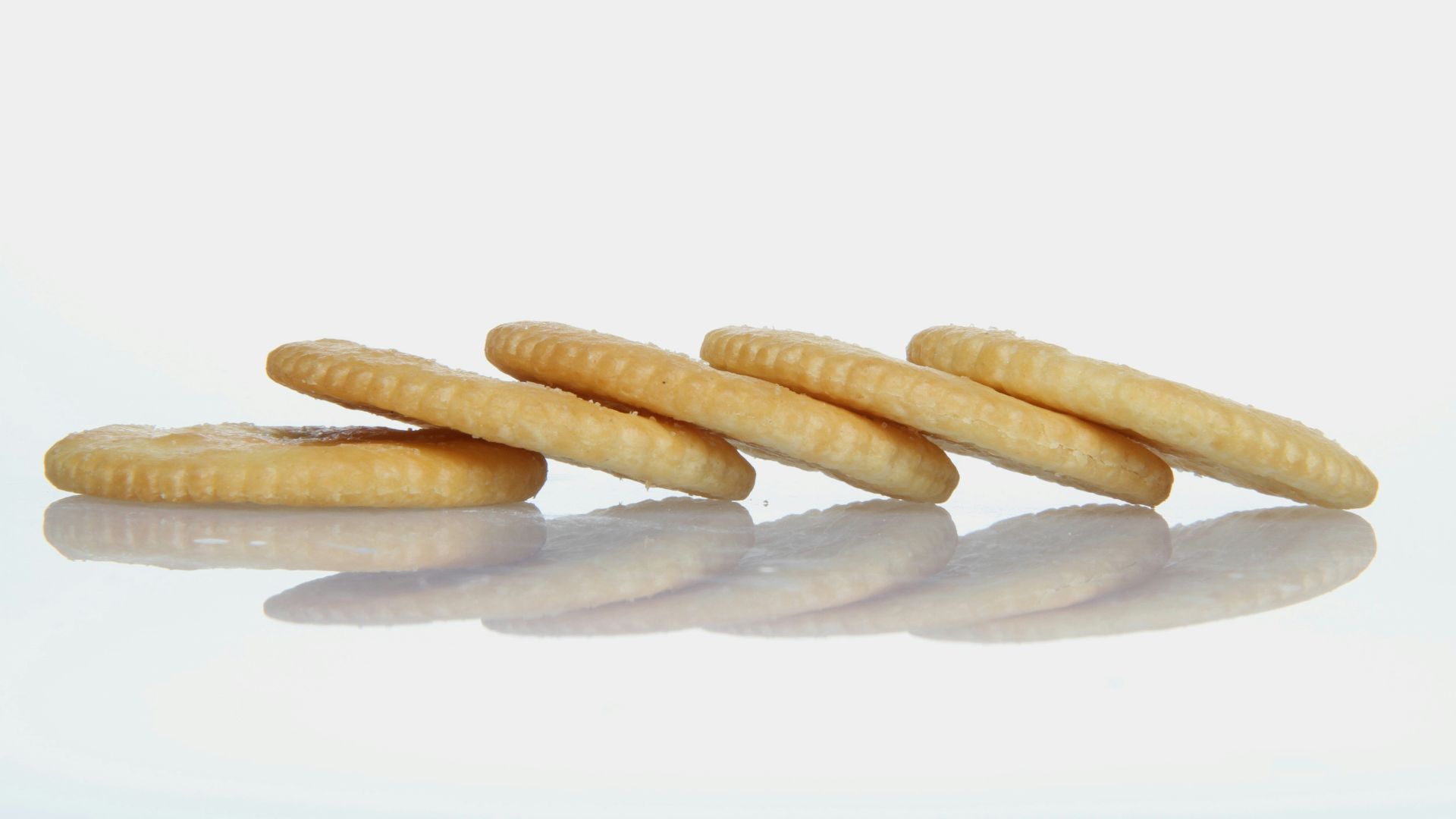 Some delicious crackers are arranged in a row.