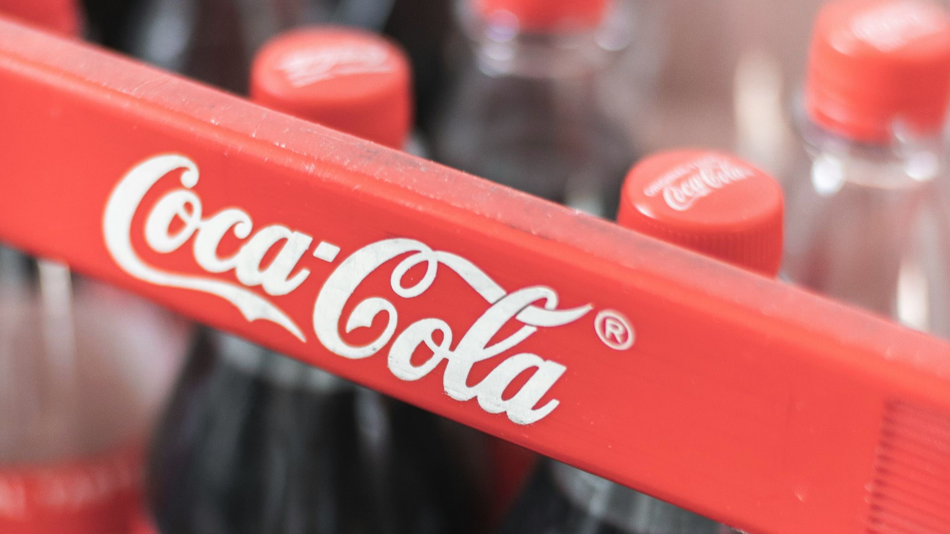 coca cola plastic bottle on red plastic crate