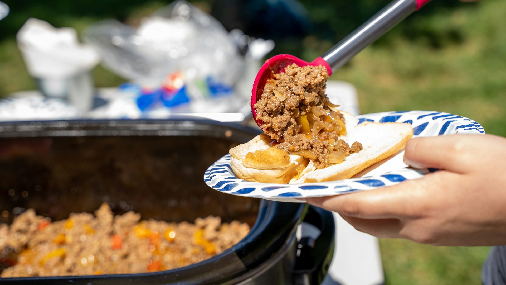 a person cutting a cake with a knife