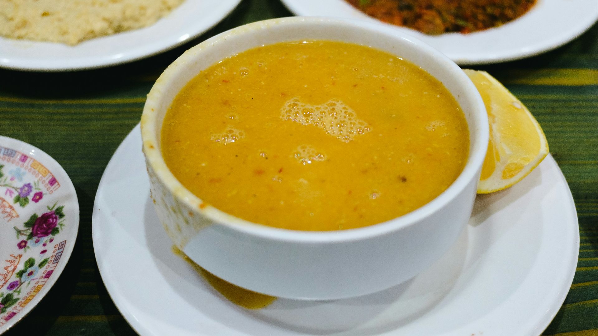 Lentil soup with accompaniments is ready to eat.