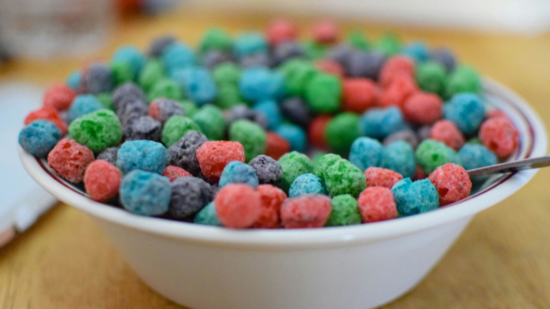 white ceramic bowl with assorted color of beads