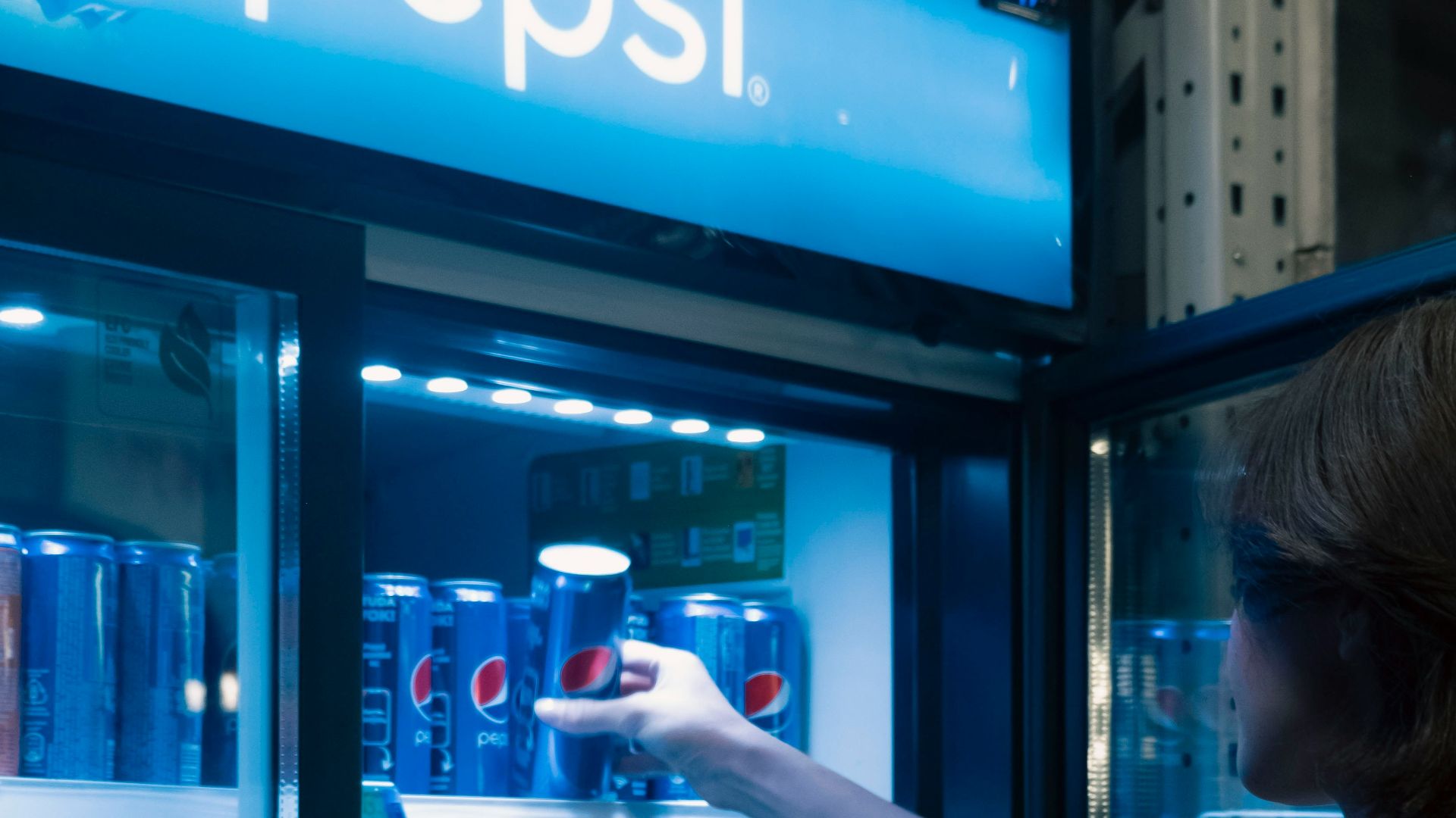 a person standing in front of a vending machine