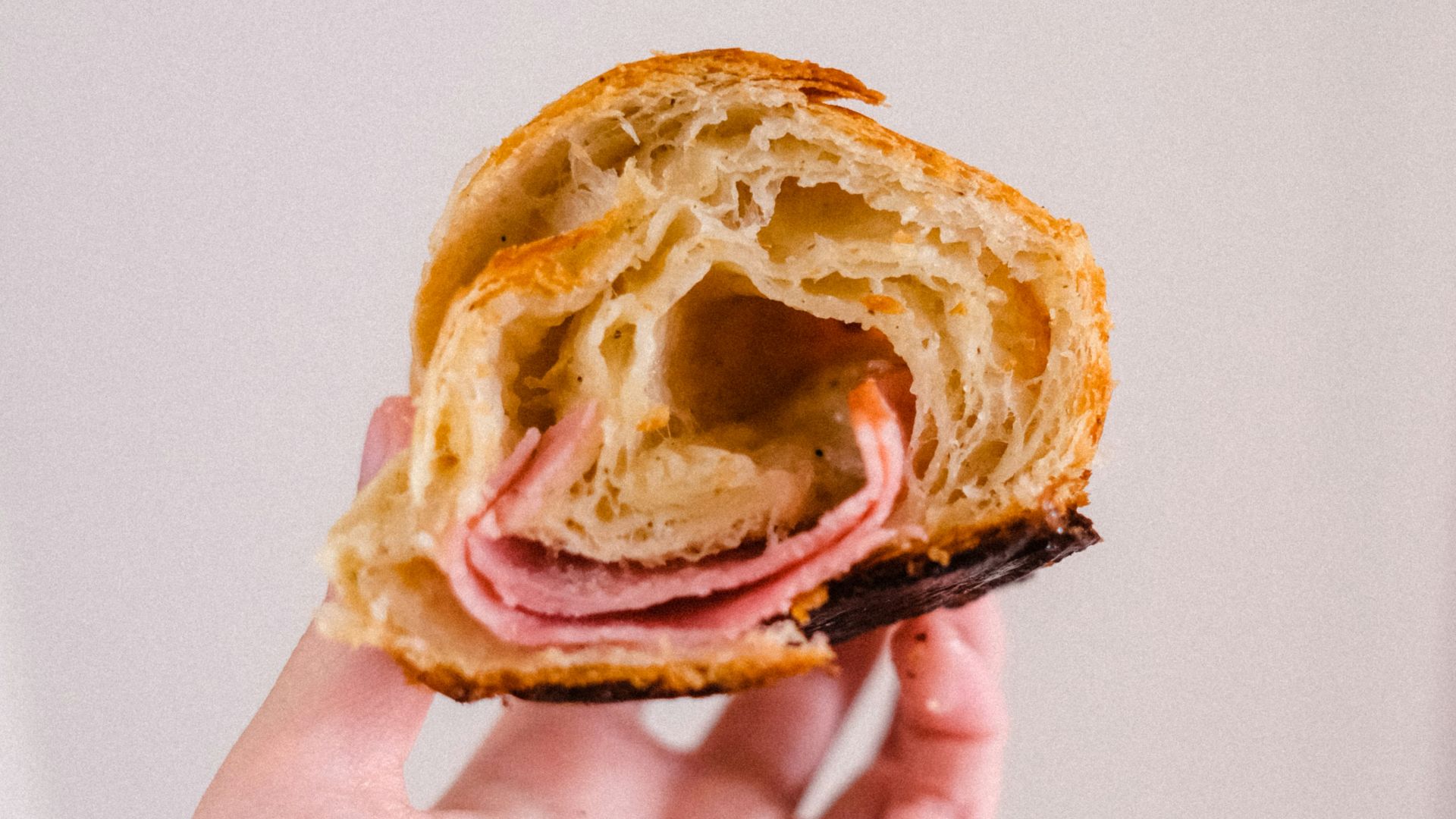 person holding brown bread with chocolate