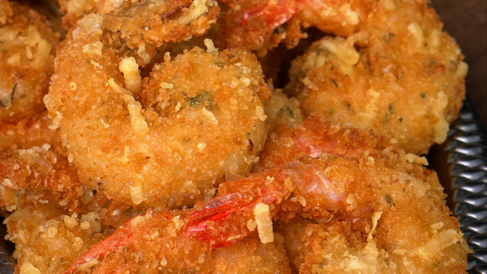 Crispy fried shrimp are arranged on a platter.