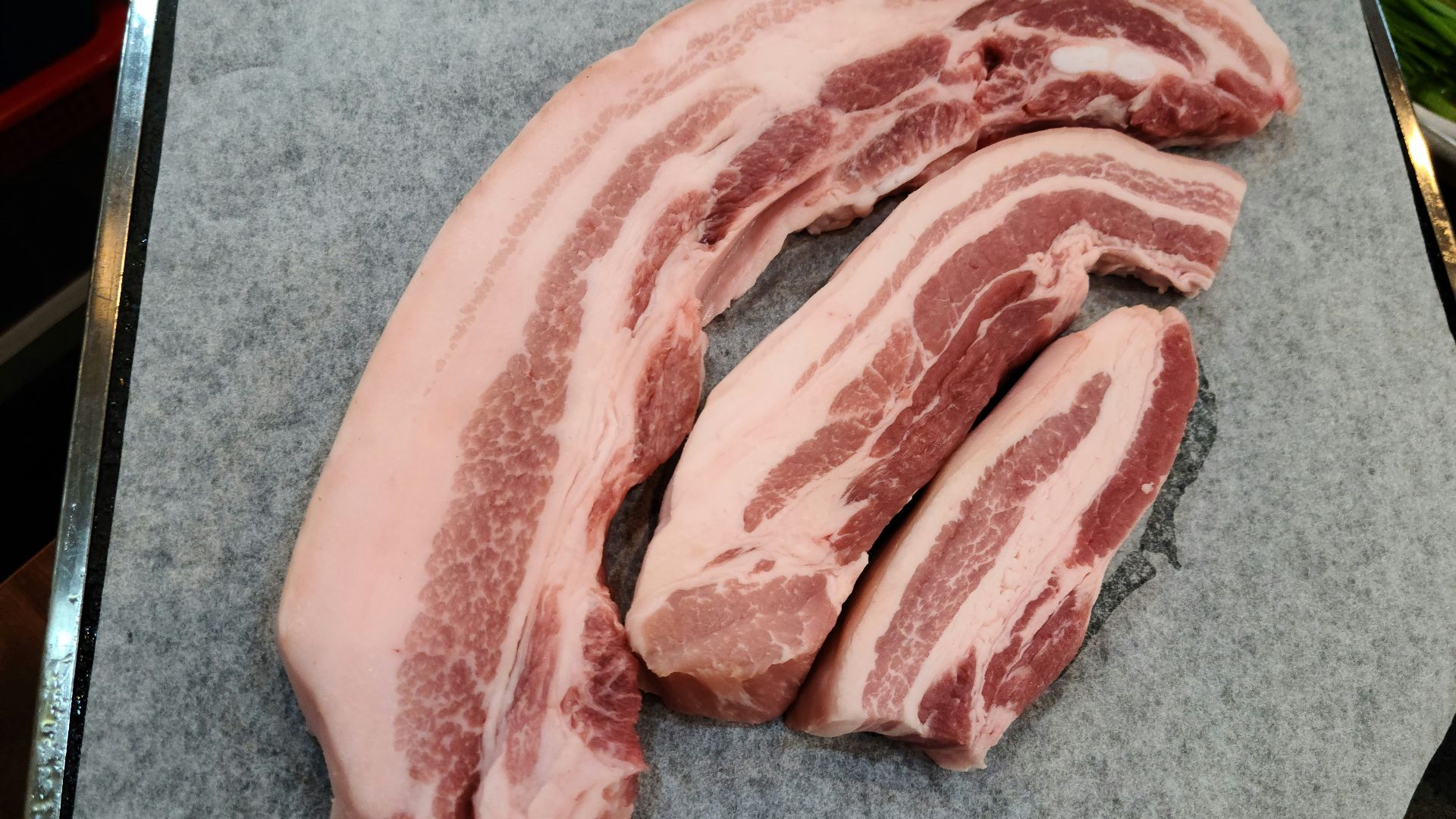 a pile of raw meat sitting on top of a cutting board