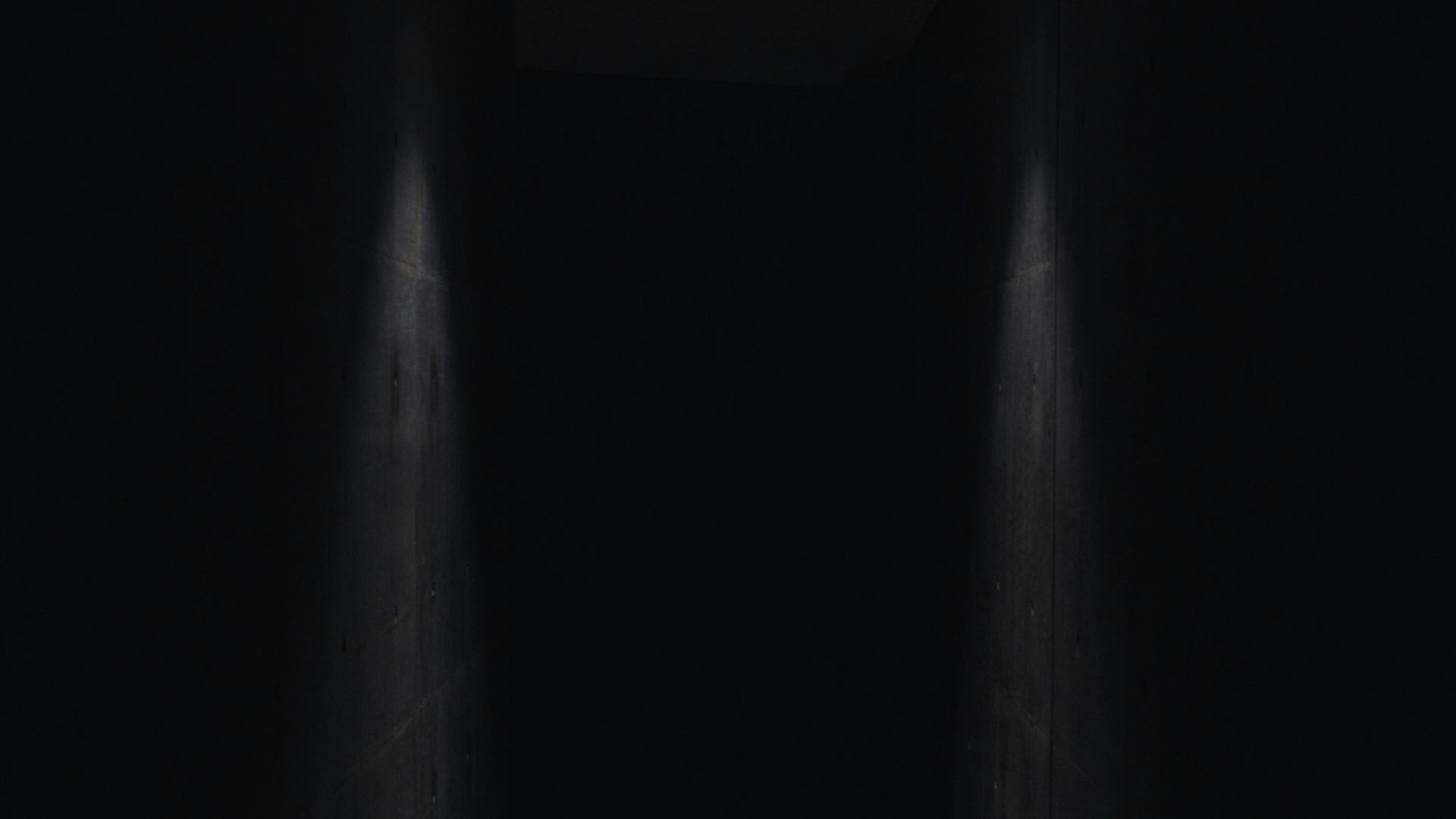 dark pathway lit with small light fixture