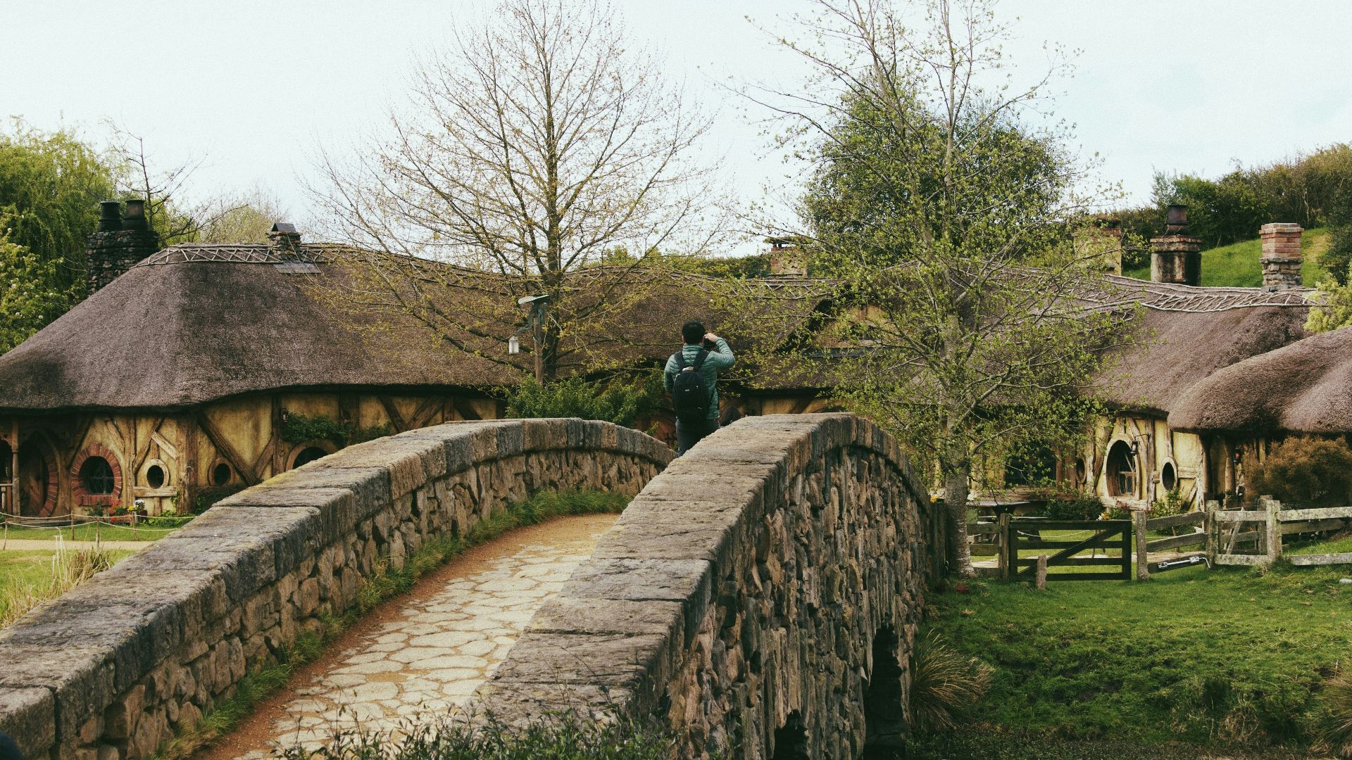 a person standing on a stone bridge