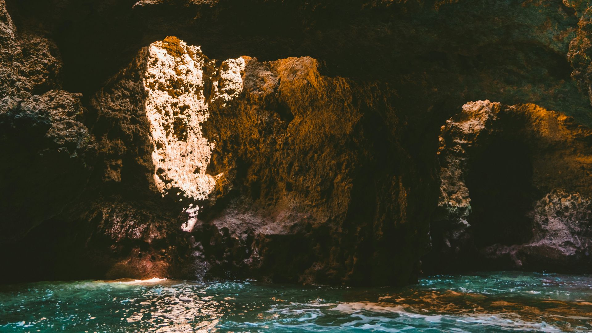 body of water under cave