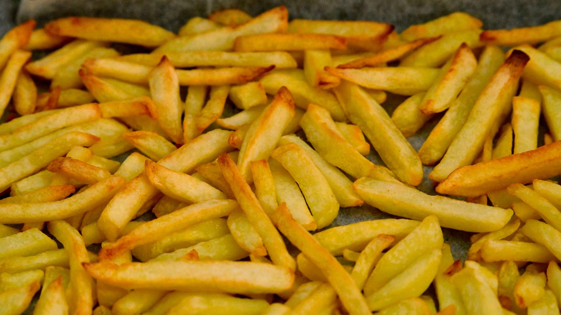 A pile of french fries sitting on top of a table
