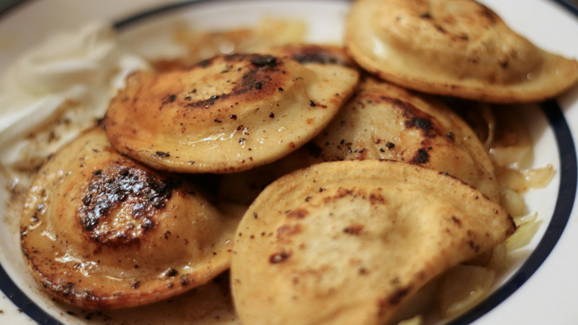 a white plate topped with potatoes and gravy