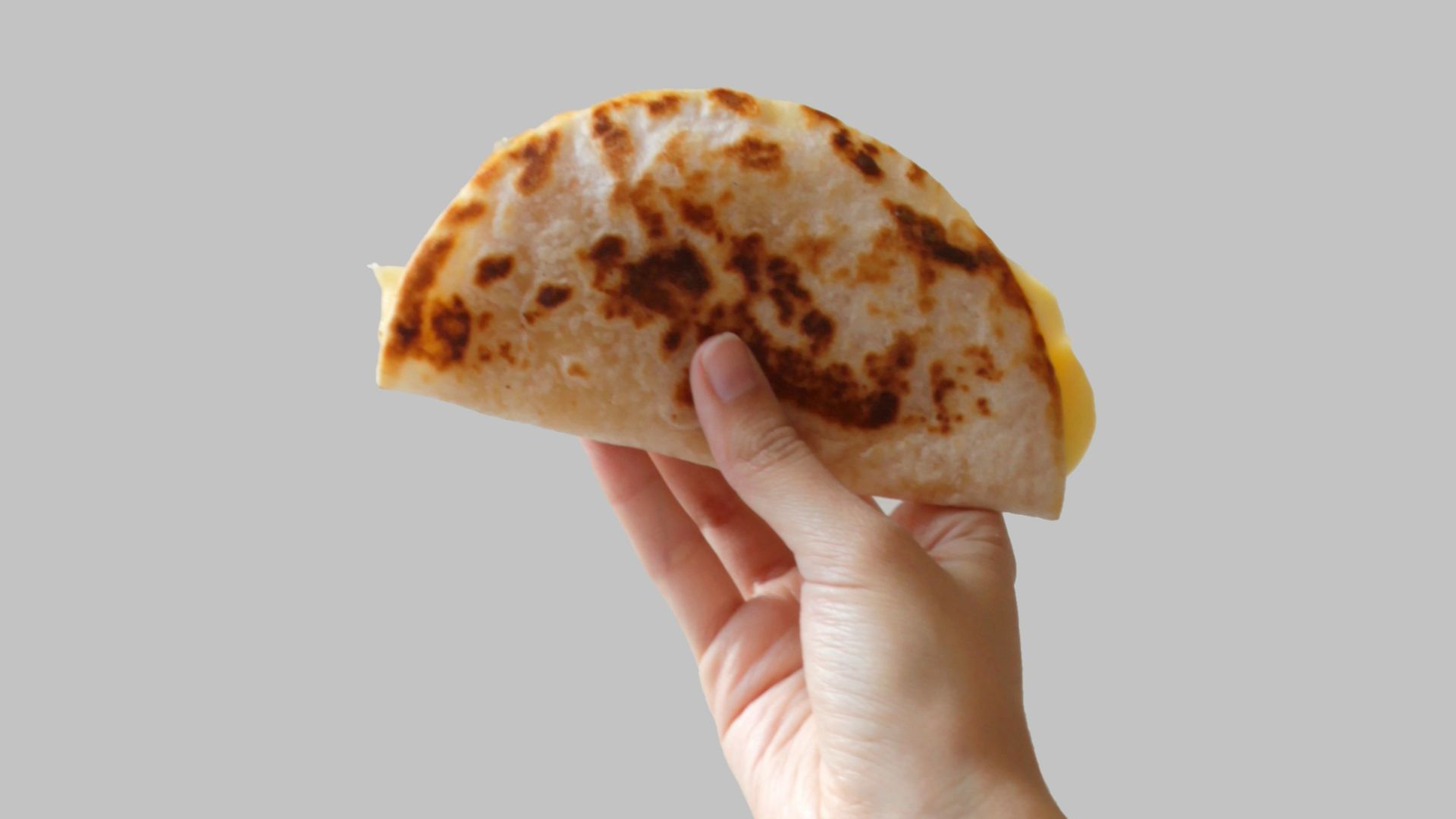 person holding pancake raising it up