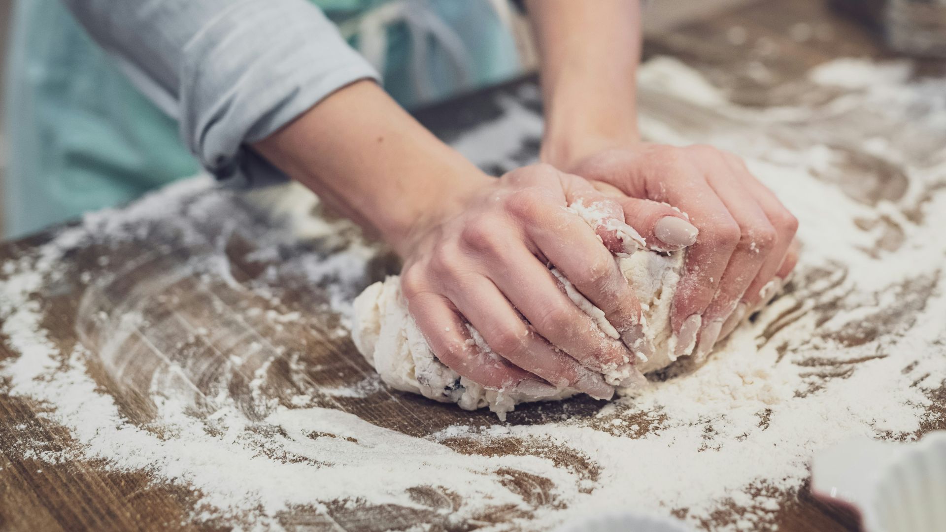 person standing and making dough