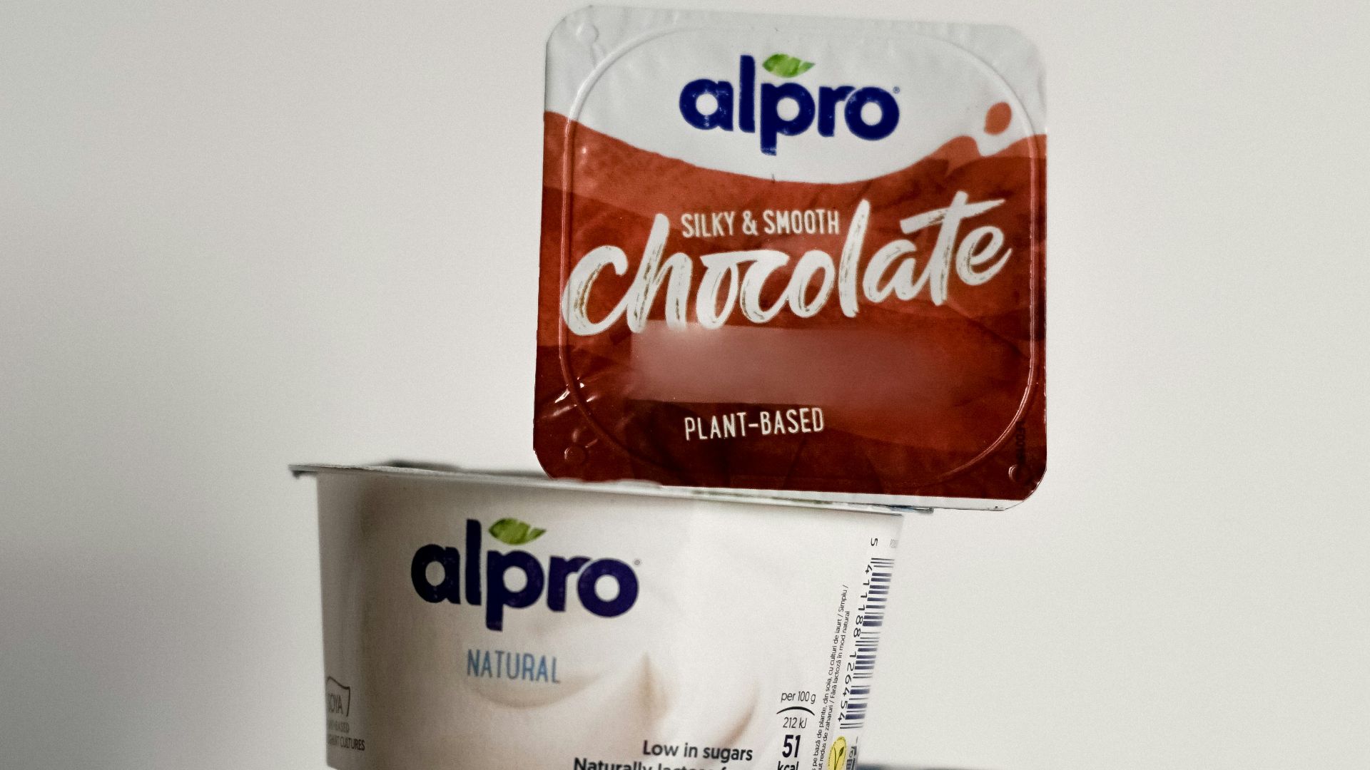 two cups of ice cream and a bag of chocolate