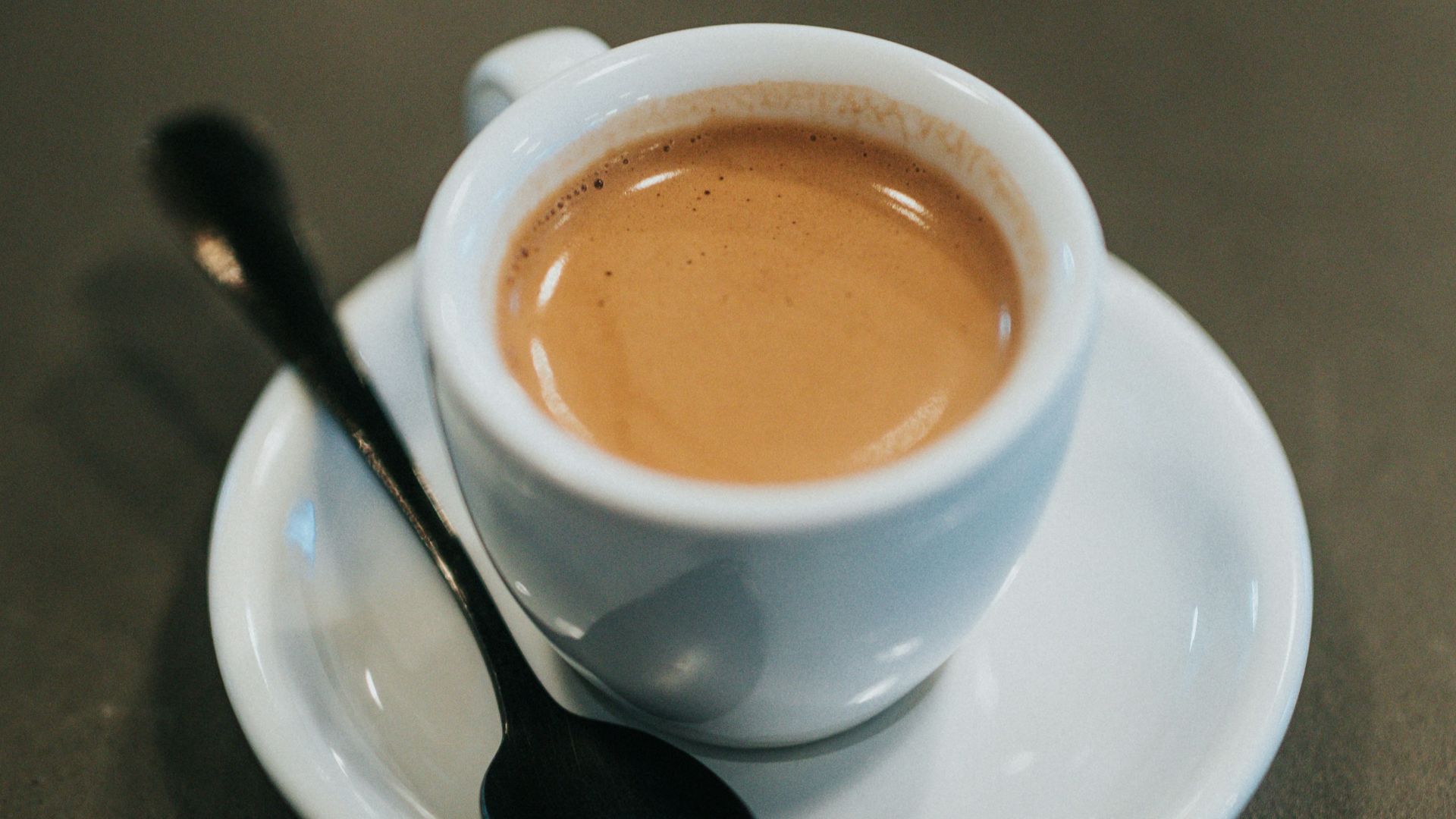 white ceramic cup with brown liquid