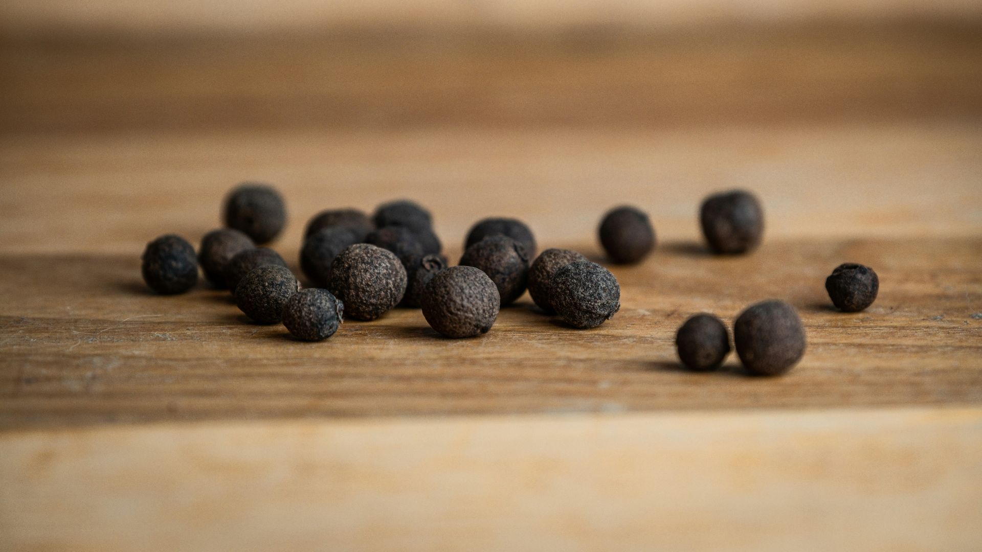 black round fruits on brown wooden table