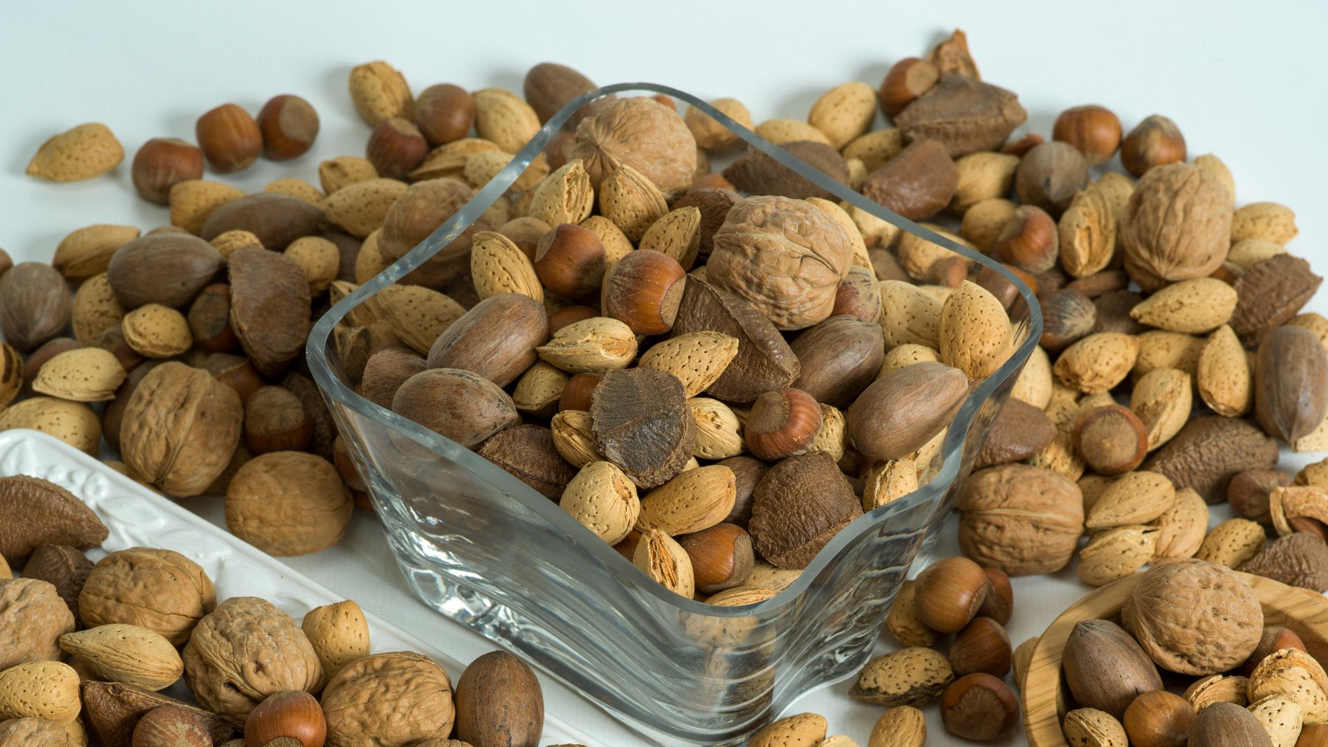 brown almond nuts on white plastic container