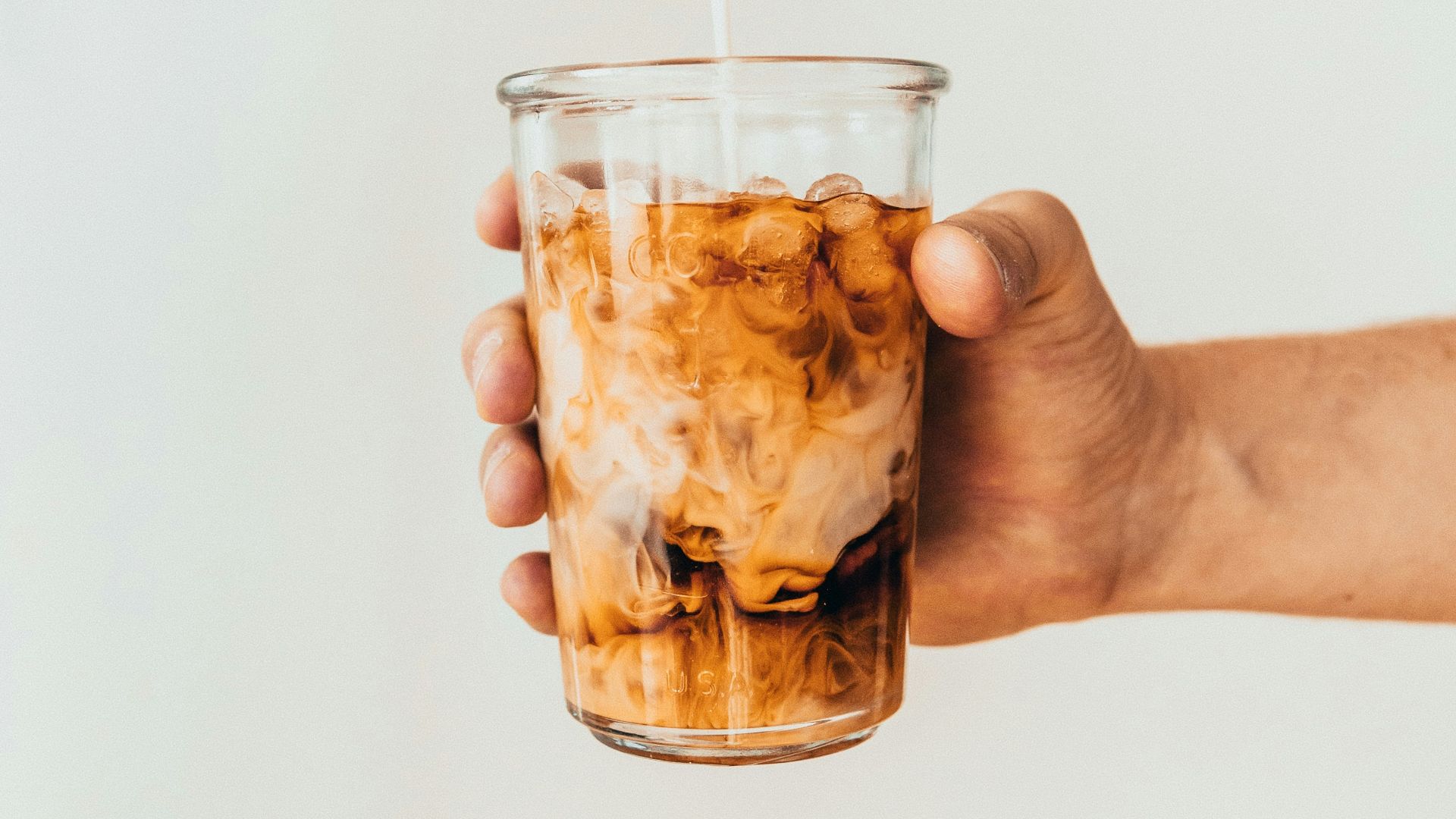 clear drinking glass with brown liquid
