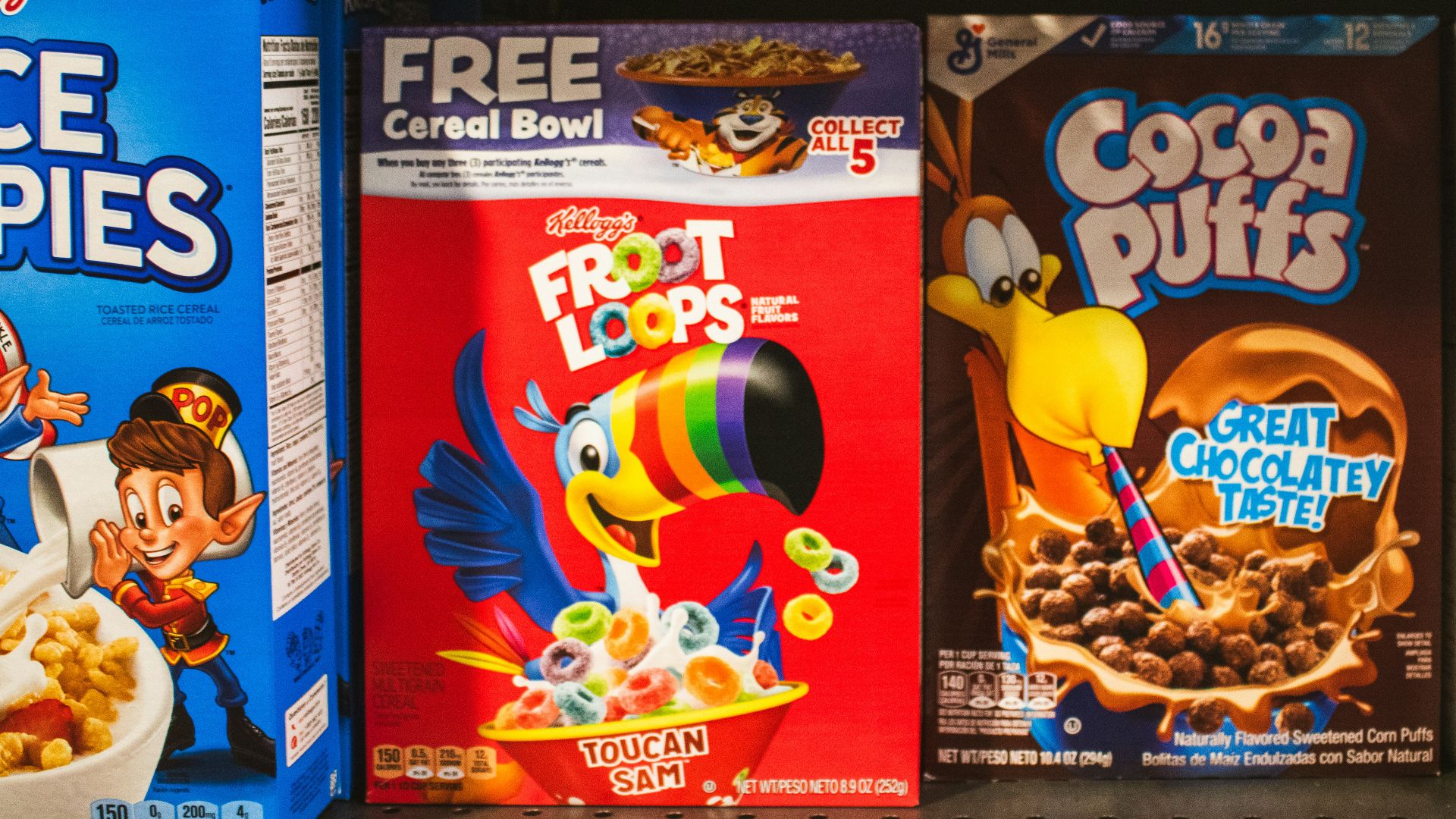 Cereal boxes displayed on a supermarket shelf.