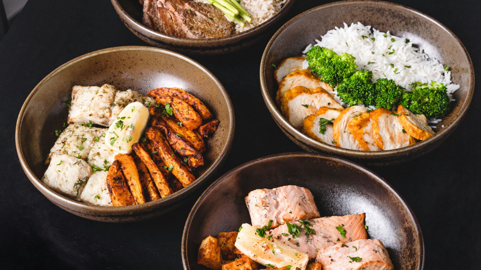 cooked food on black ceramic bowls
