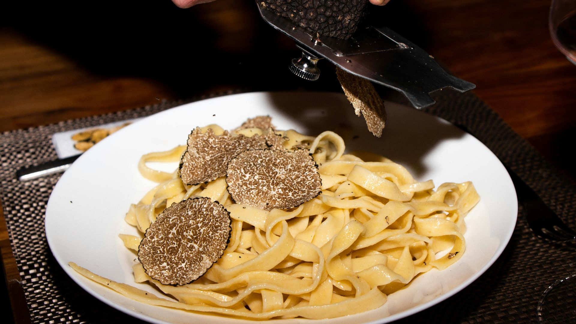 a plate of pasta with meatballs and a knife