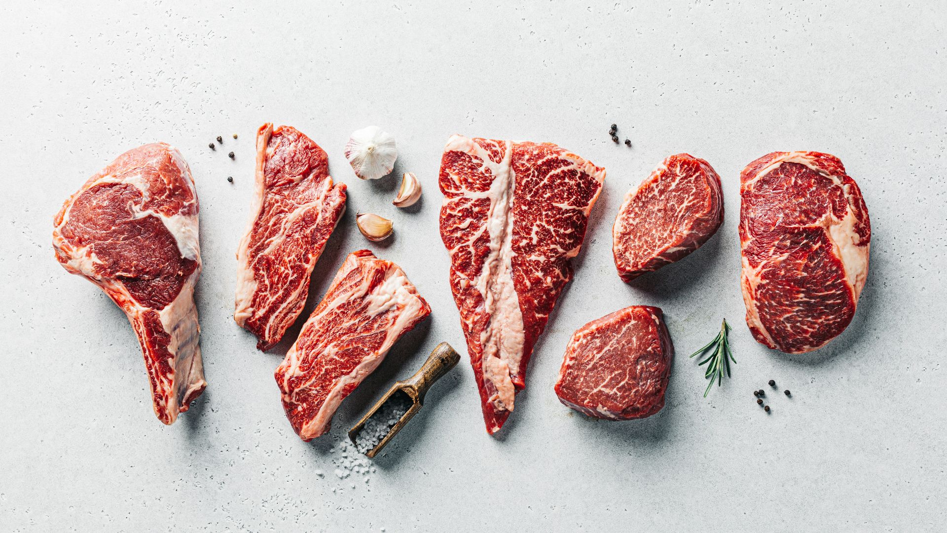 a group of raw meats on a table