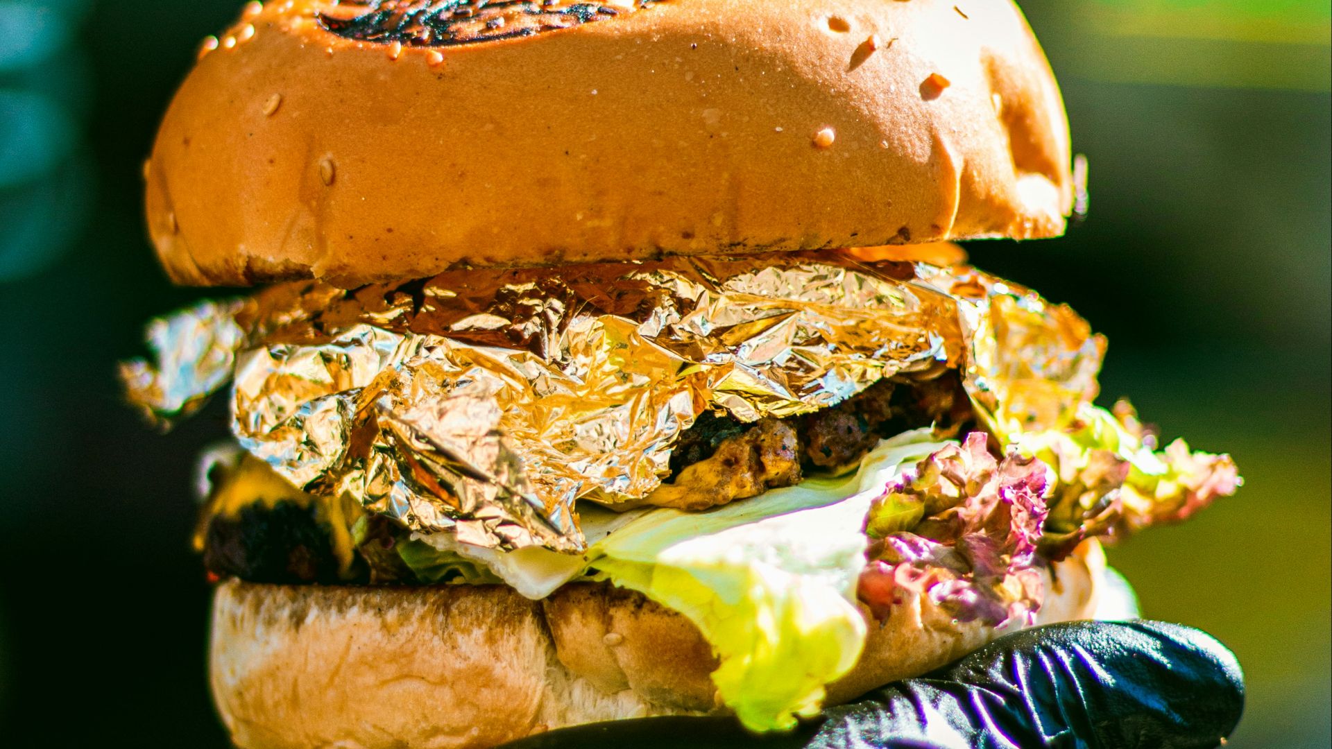 a person holding a sandwich in their hand