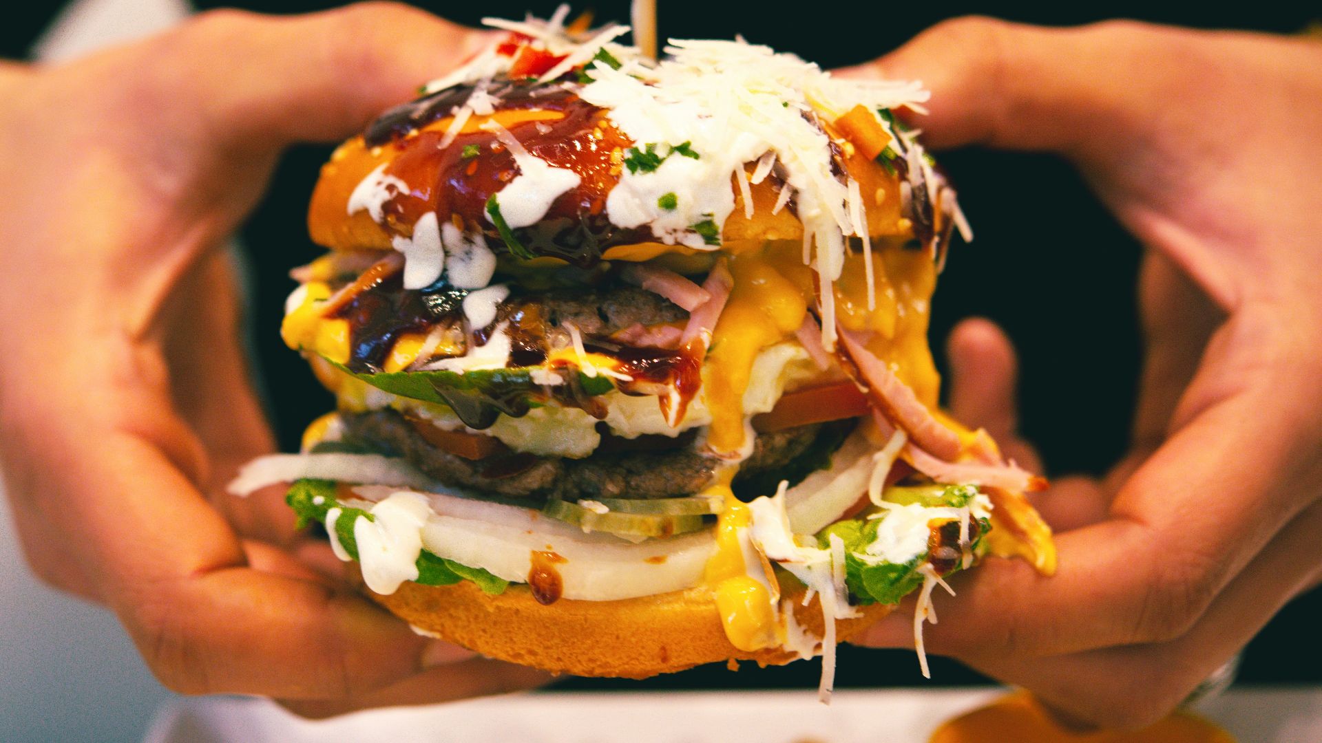a person holding a burger