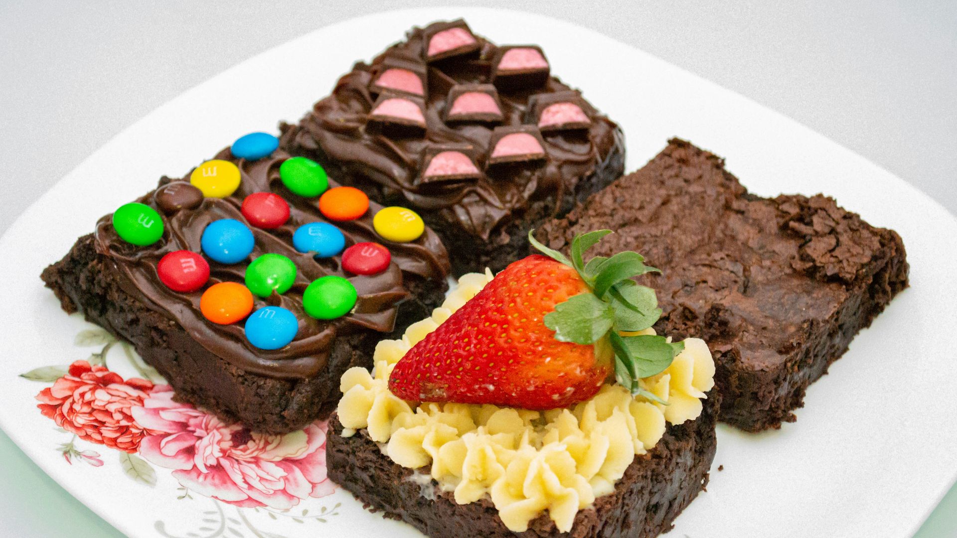 a white plate topped with brownies covered in candy