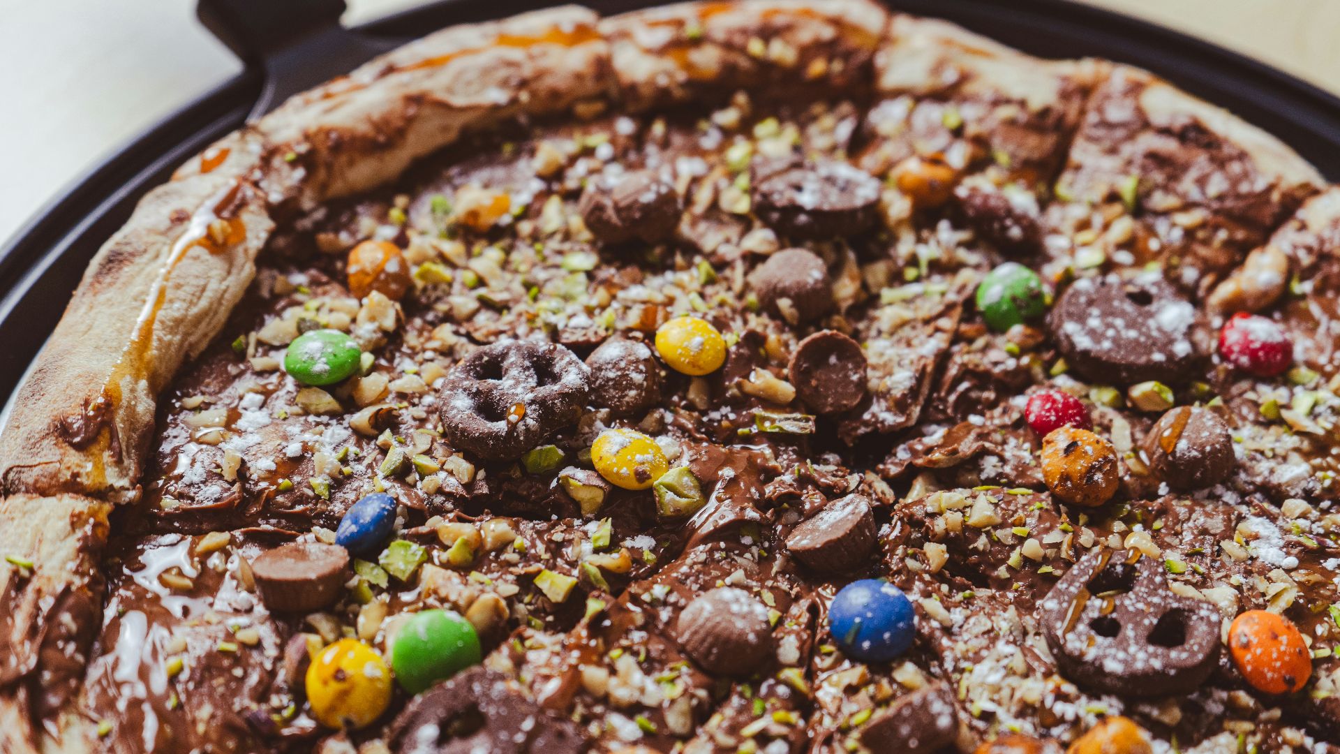 a close up of a pizza on a pan on a table