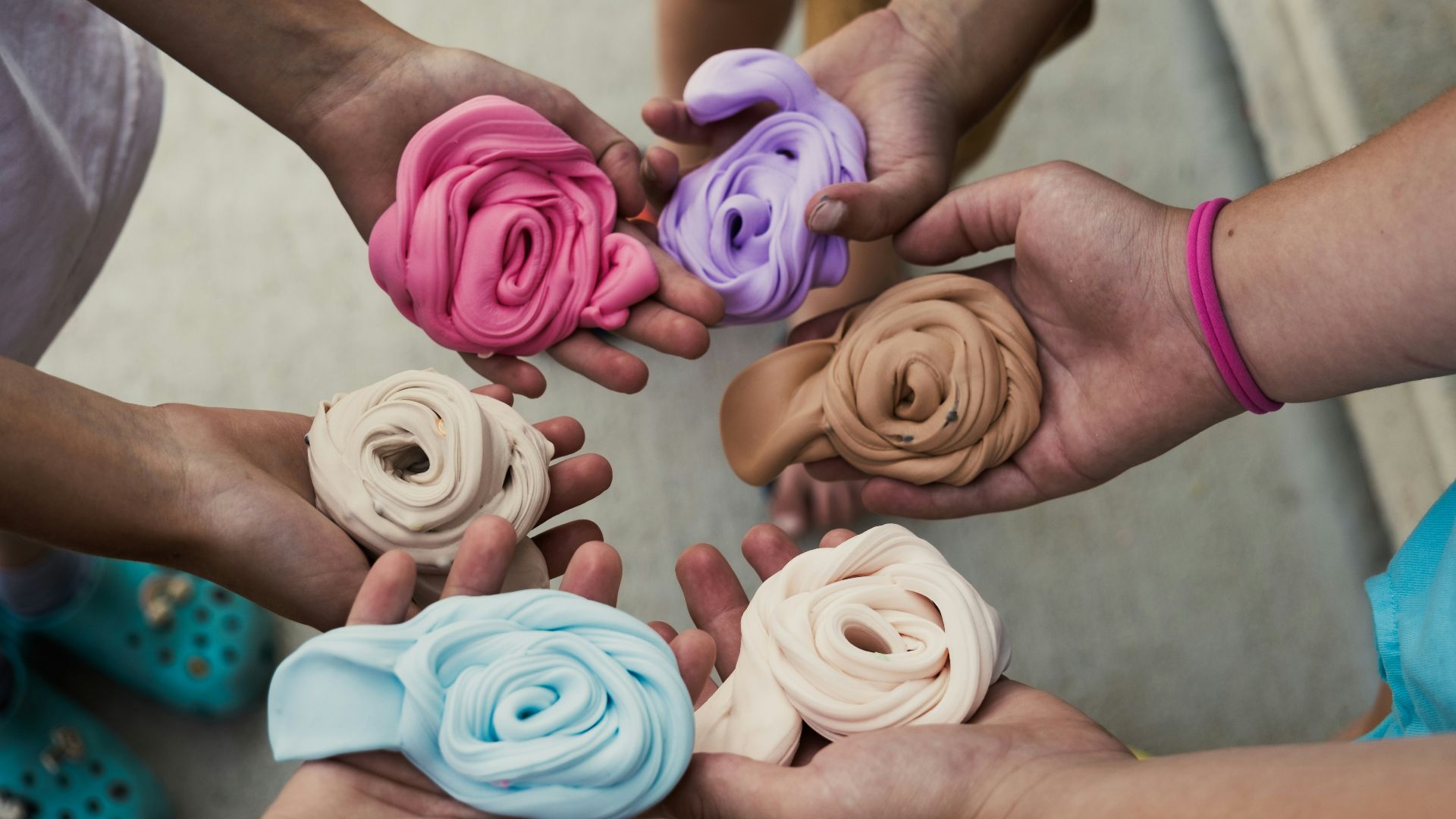 a group of people holding different colored flowers