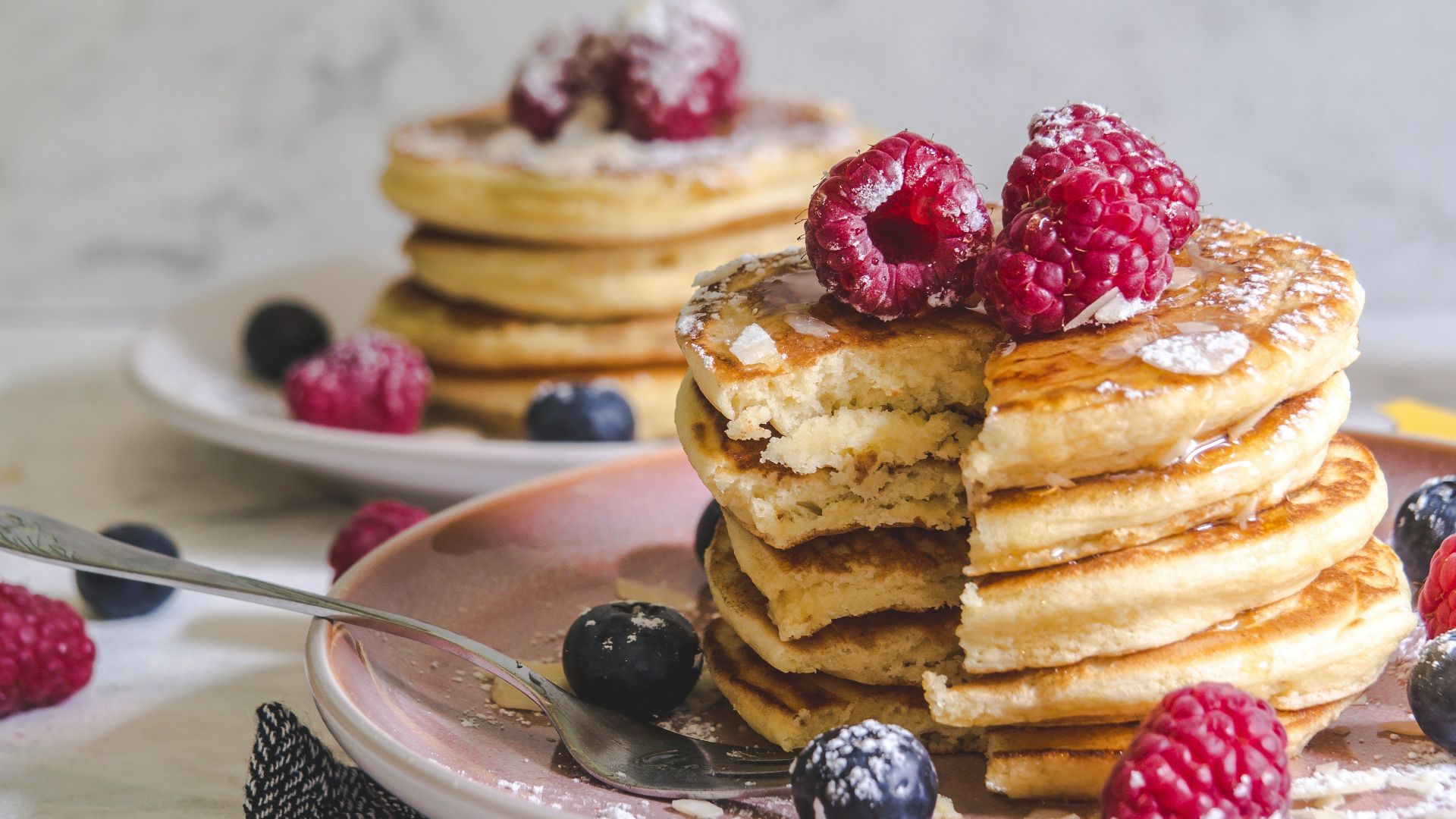 pancakes with berries on white ceramic plate