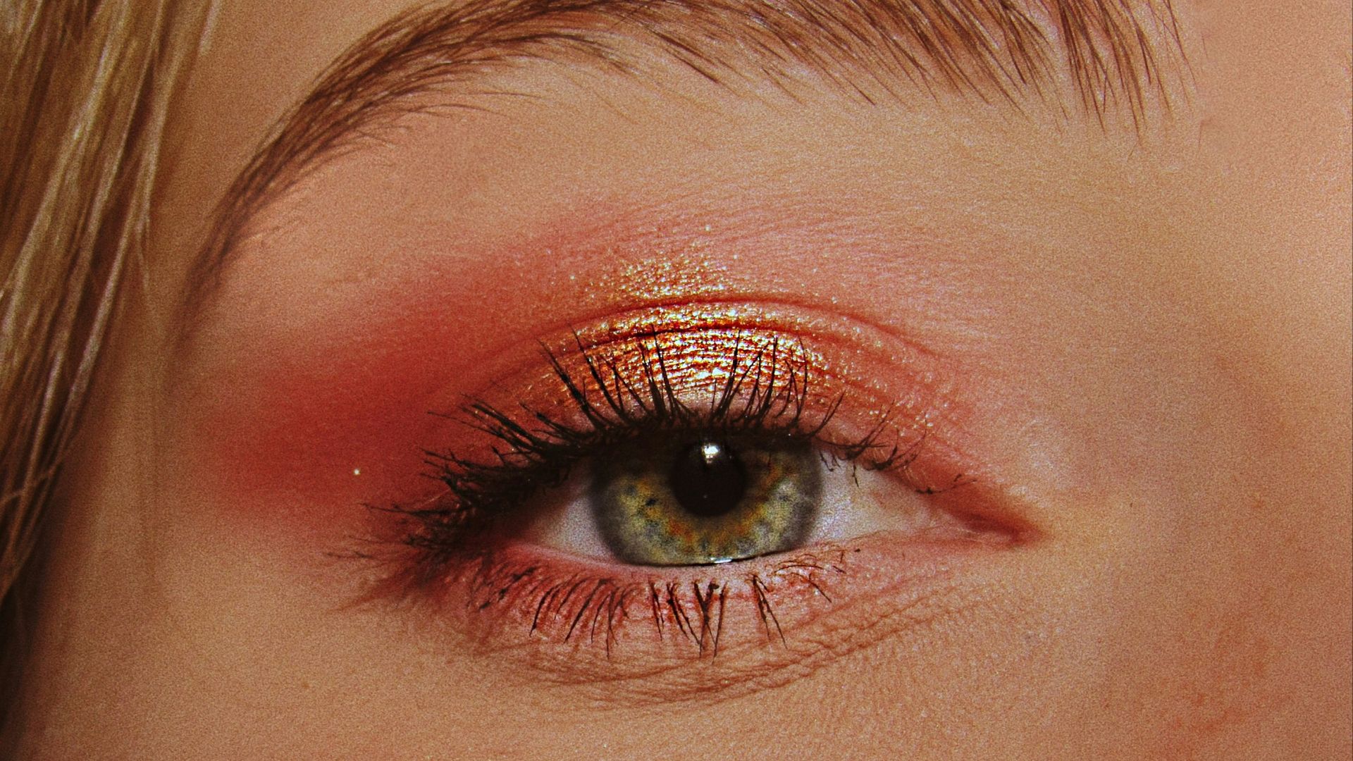 woman with pink and gold eyeshadow makeup