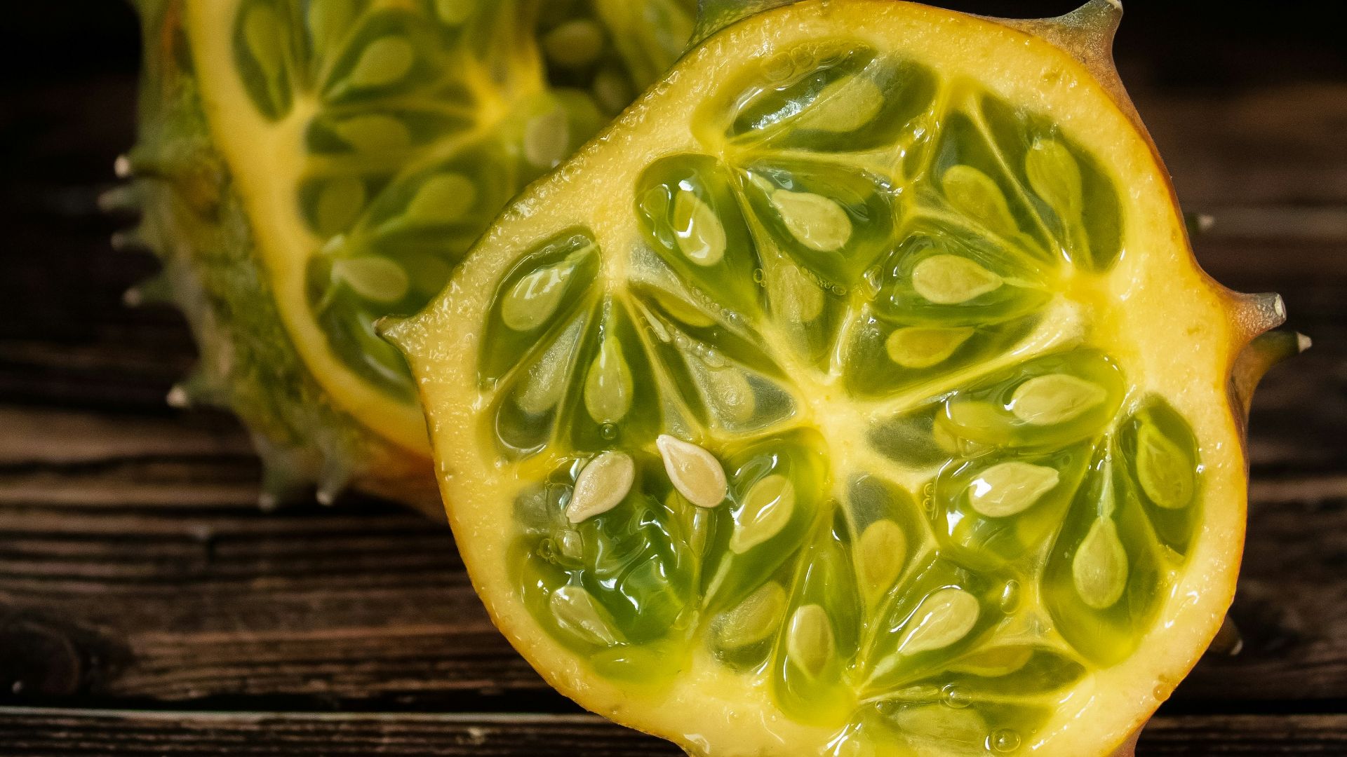 a couple of pieces of fruit sitting on top of a wooden table