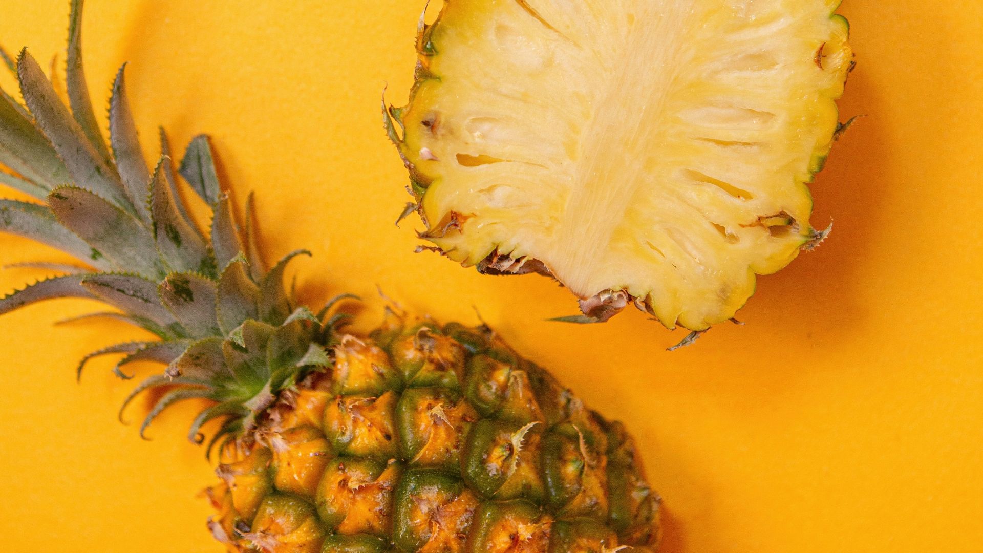 pineapple fruit on yellow surface
