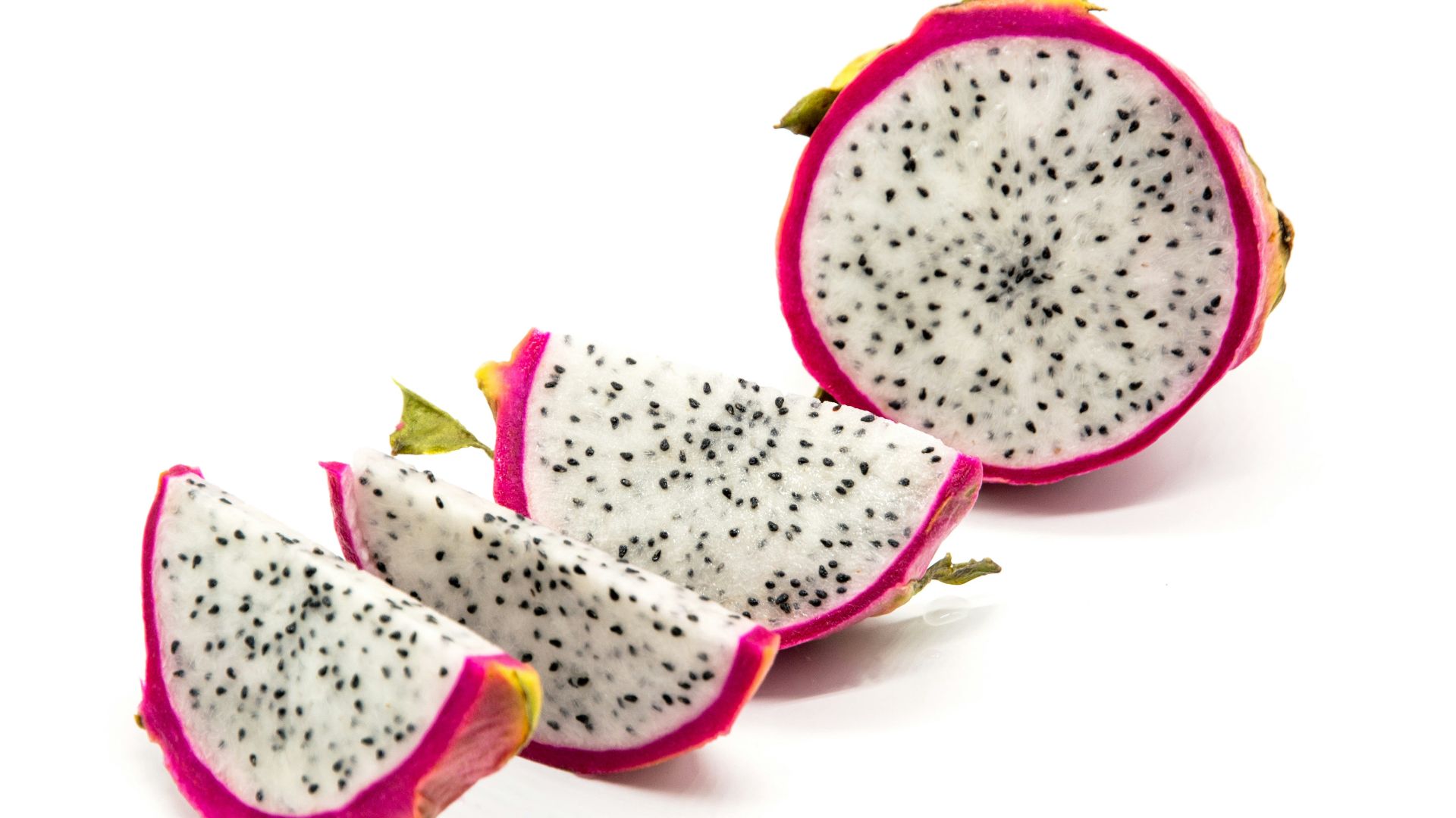 a cut in half dragon fruit on a white background