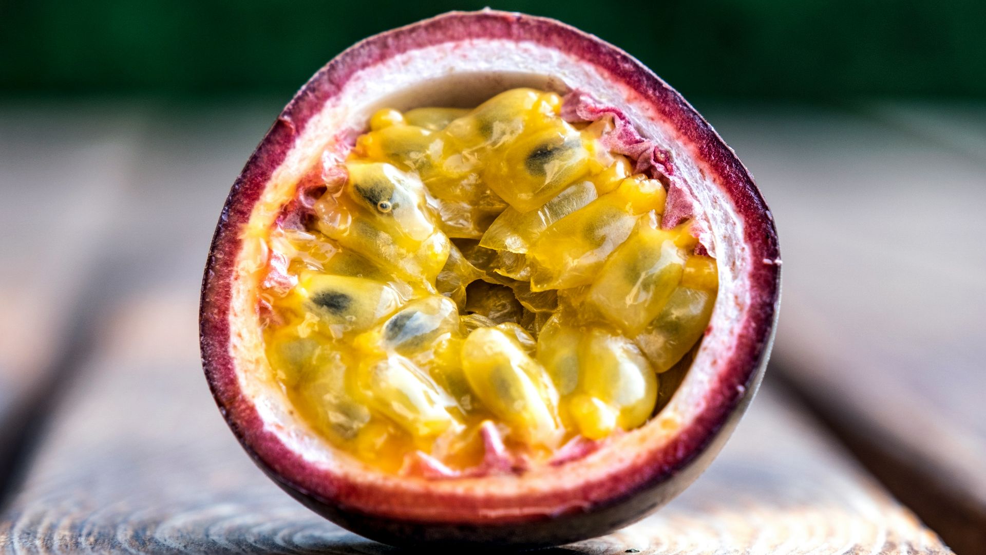 red and yellow round fruit on brown wooden table