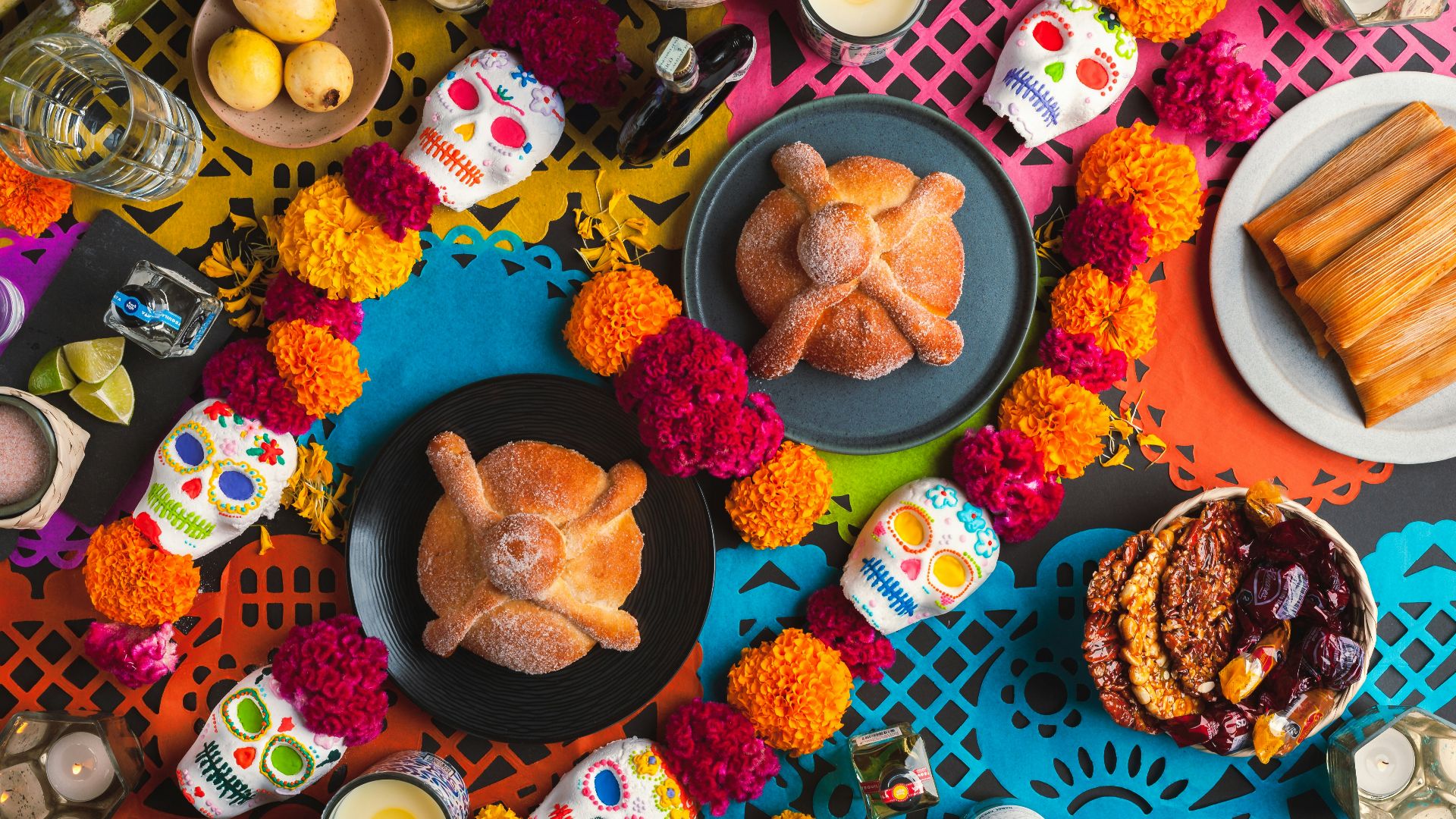 a table topped with plates of food and candles