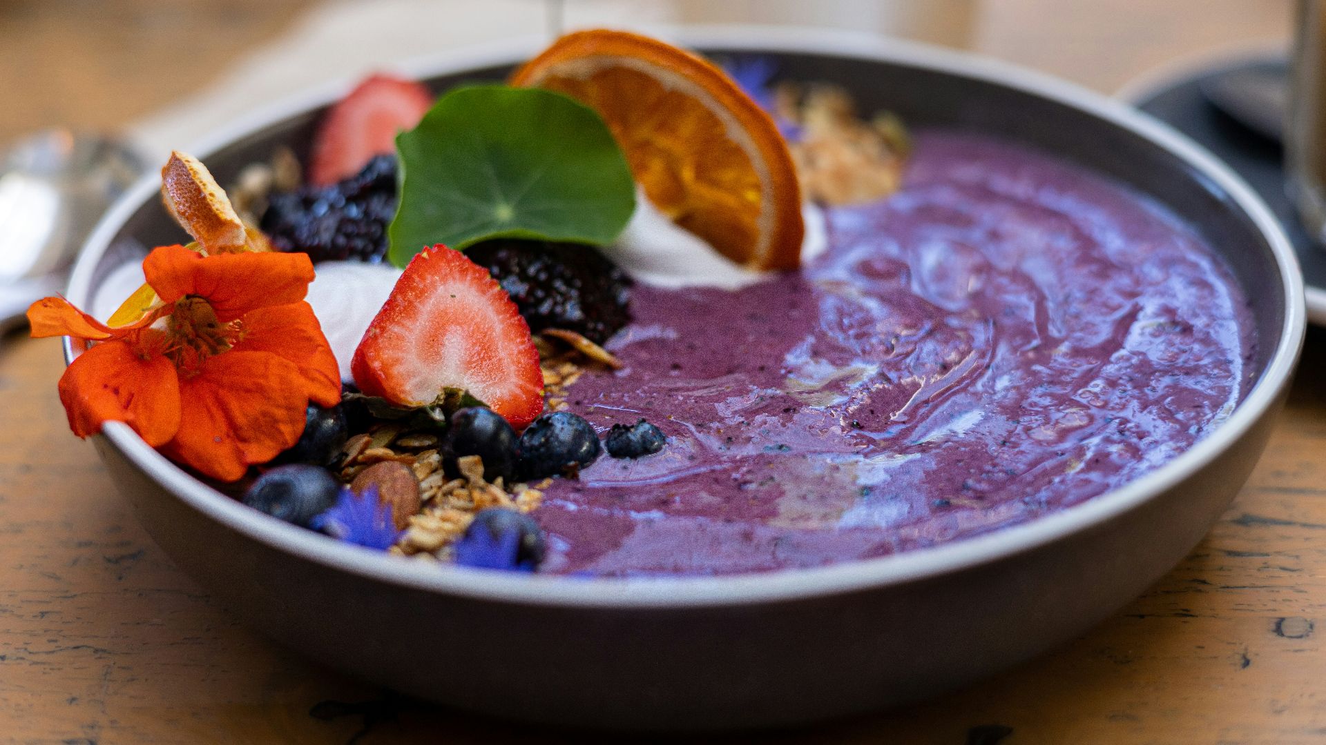 a bowl of fruit and yogurt on a table