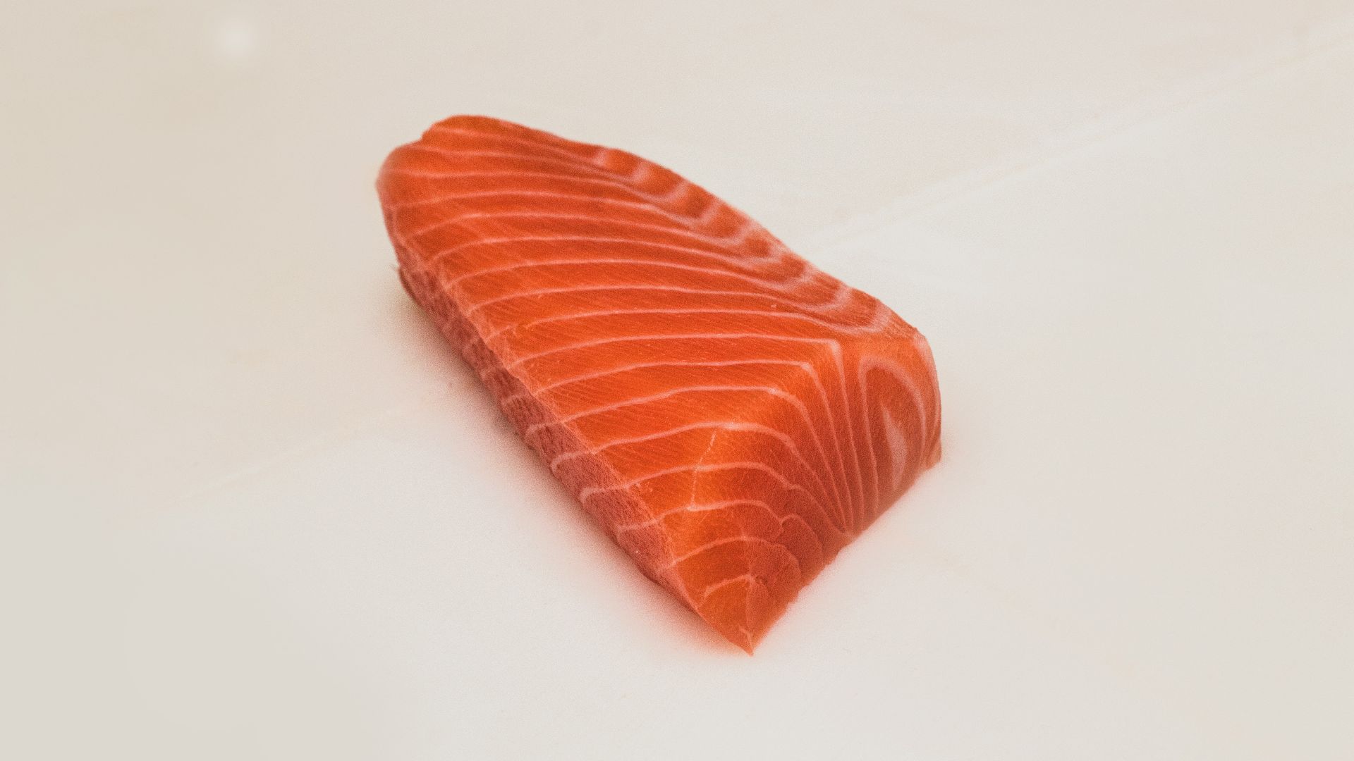 sliced fish meat on white surface