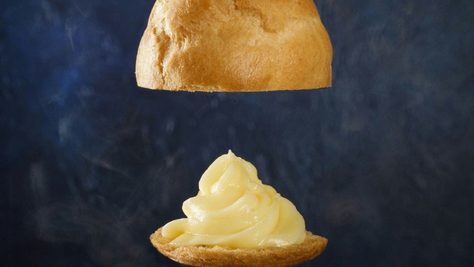 burger with brown syrup on black surface