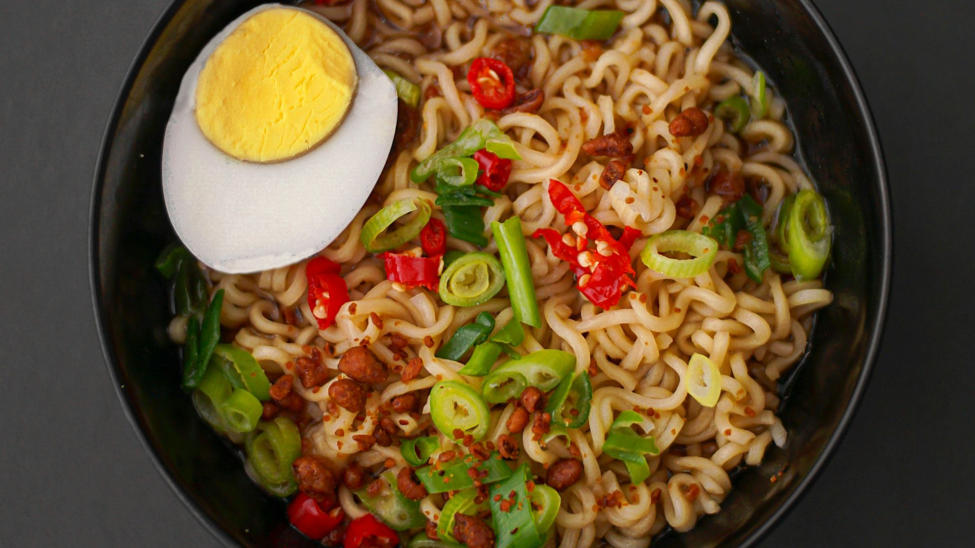 noodles with sliced lemon on black ceramic bowl