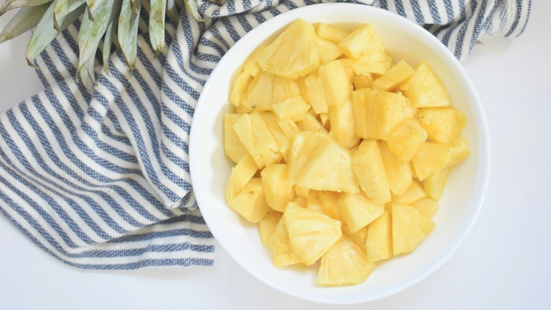 yellow and green pineapple fruit on white ceramic plate