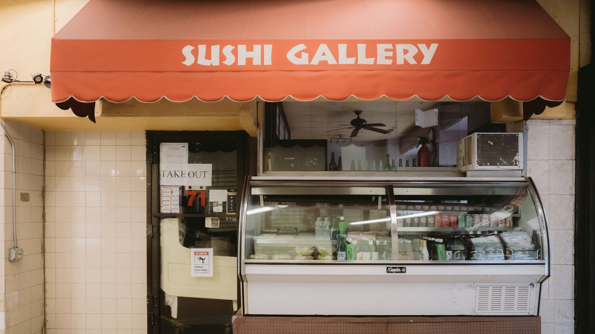 A sushi gallery establishment sits under an awning.